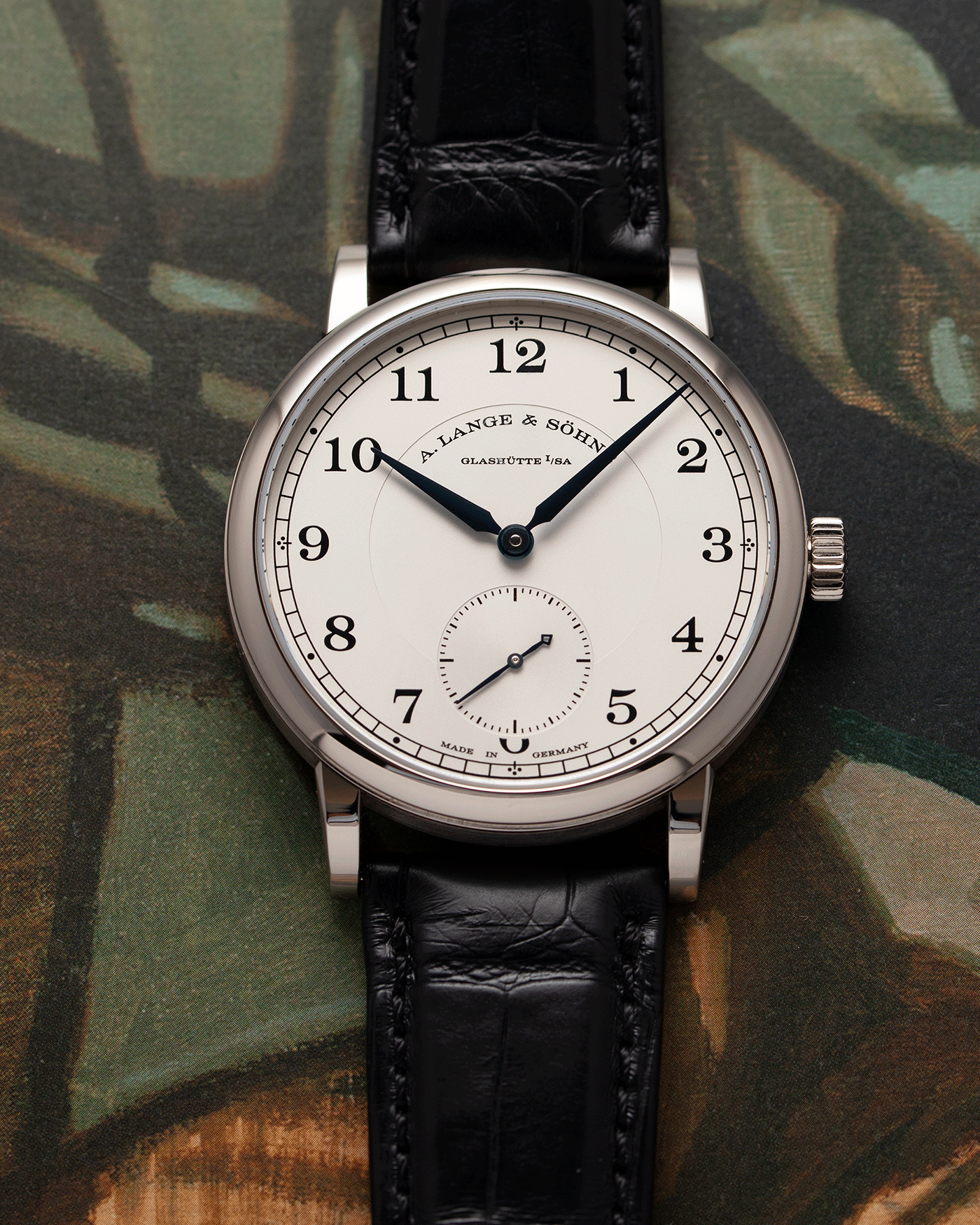 Brand: A. Lange & Sohne Year: 2010’s Model: 1815 Annual Calendar Ref Number: 235.026 Material: 18k White Gold Movement: Manual Winding In-House Cal. L051.1 Case Diameter: 38mm Bracelet/Strap: A. Lange & Sohne Black Alligator Strap with signed 18k White Gold Tang Buckle