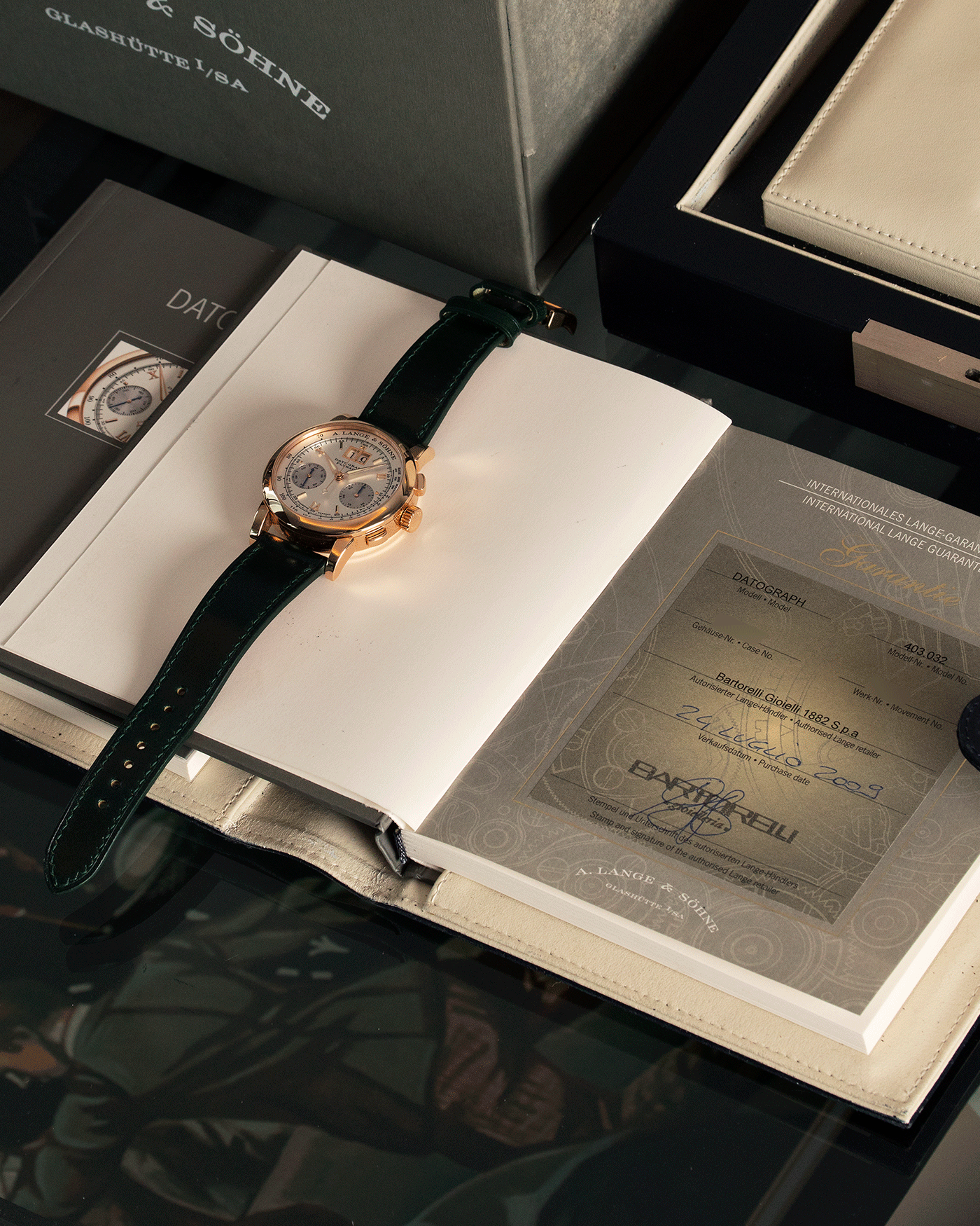 Brand: A. Lange & Sohne Year: 2009 Model: Datograph Reference Number: 403.032 Material: 18k Rose Gold Movement: Manual Winding L951.1 Case Diameter: 39mm Bracelet/Strap: Delugs Green Leather Strap with signed 18k Rose Gold Tang Buckle