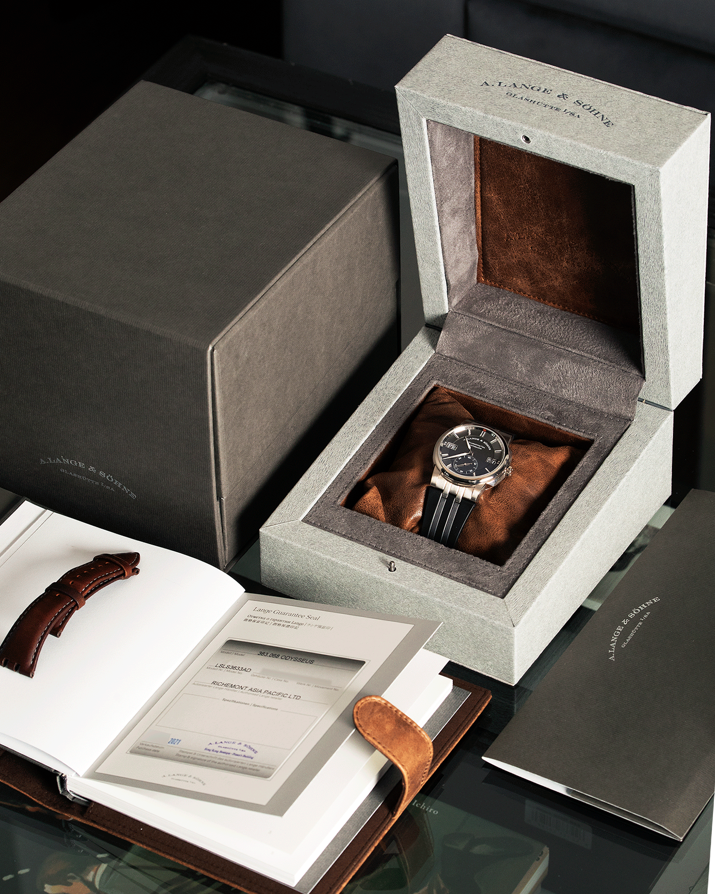 Brand: A. Lange & Sohne Year: 2021 Model: Datomatic Odysseus Ref Number: 363.038 Material: 18k White Gold Movement: Self-Winding In-House L155.1 Case Diameter: 38mm Bracelet/Strap: A. Lange & Sohne Brown Leather Strap and Black Rubber Strap with signed 18k White Gold Tang Buckle