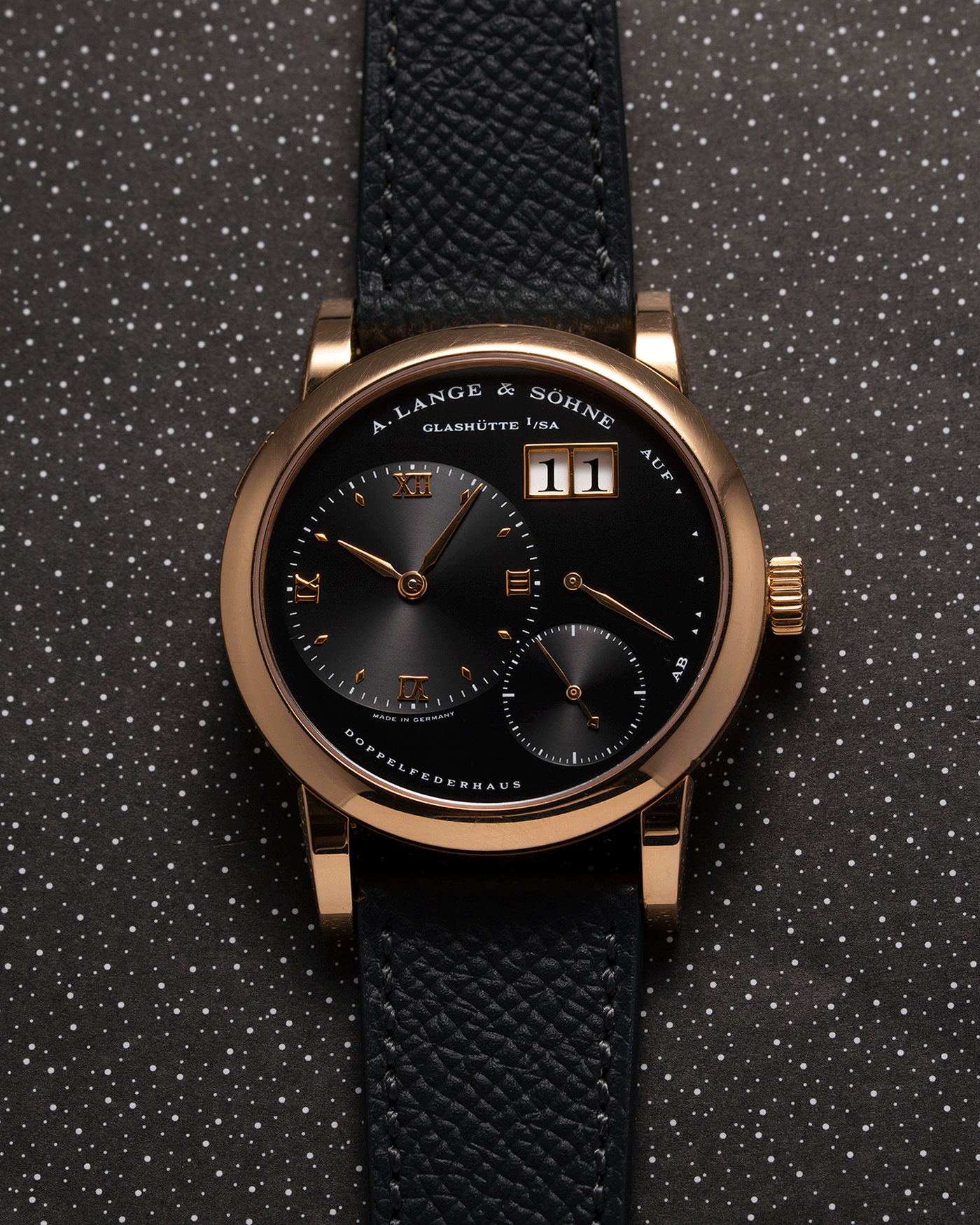 Brand: A. Lange & Sohne Year: 2004 Model: Lange 1 Reference Number: 101.031 Material: 18k Rose Gold Movement: Manual Winding L901.5 Case Diameter: 38.5mm Bracelet/Strap: Nostime Anthracite Textured Calf with 18k Rose Gold Tang Buckle