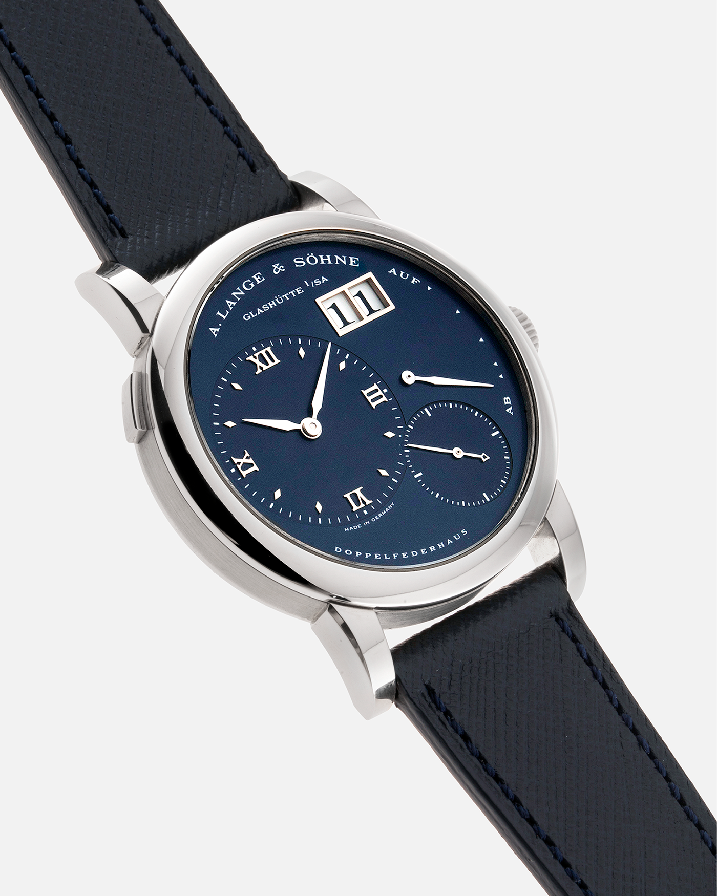 Brand: A. Lange & Sohne Year: 2000’s Model: Lange 1  Reference Number: 101.027 Material: 18k White Gold Movement: Manual Winding L901.5 Case Diameter: 38.5mm Bracelet/Strap: Molequin Navy Blue Textured Calf with 18k White Gold A. Lange & Sohne Tang Buckle