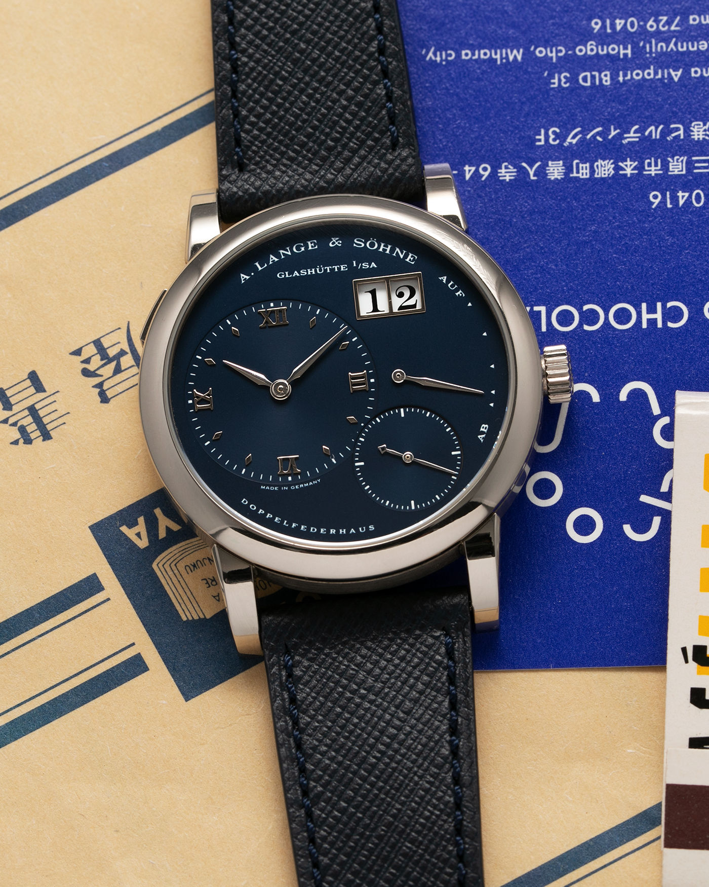 Brand: A. Lange & Sohne Year: 2000’s Model: Lange 1  Reference Number: 101.027 Material: 18k White Gold Movement: Manual Winding L901.5 Case Diameter: 38.5mm Bracelet/Strap: Molequin Navy Blue Textured Calf with 18k White Gold A. Lange & Sohne Tang Buckle