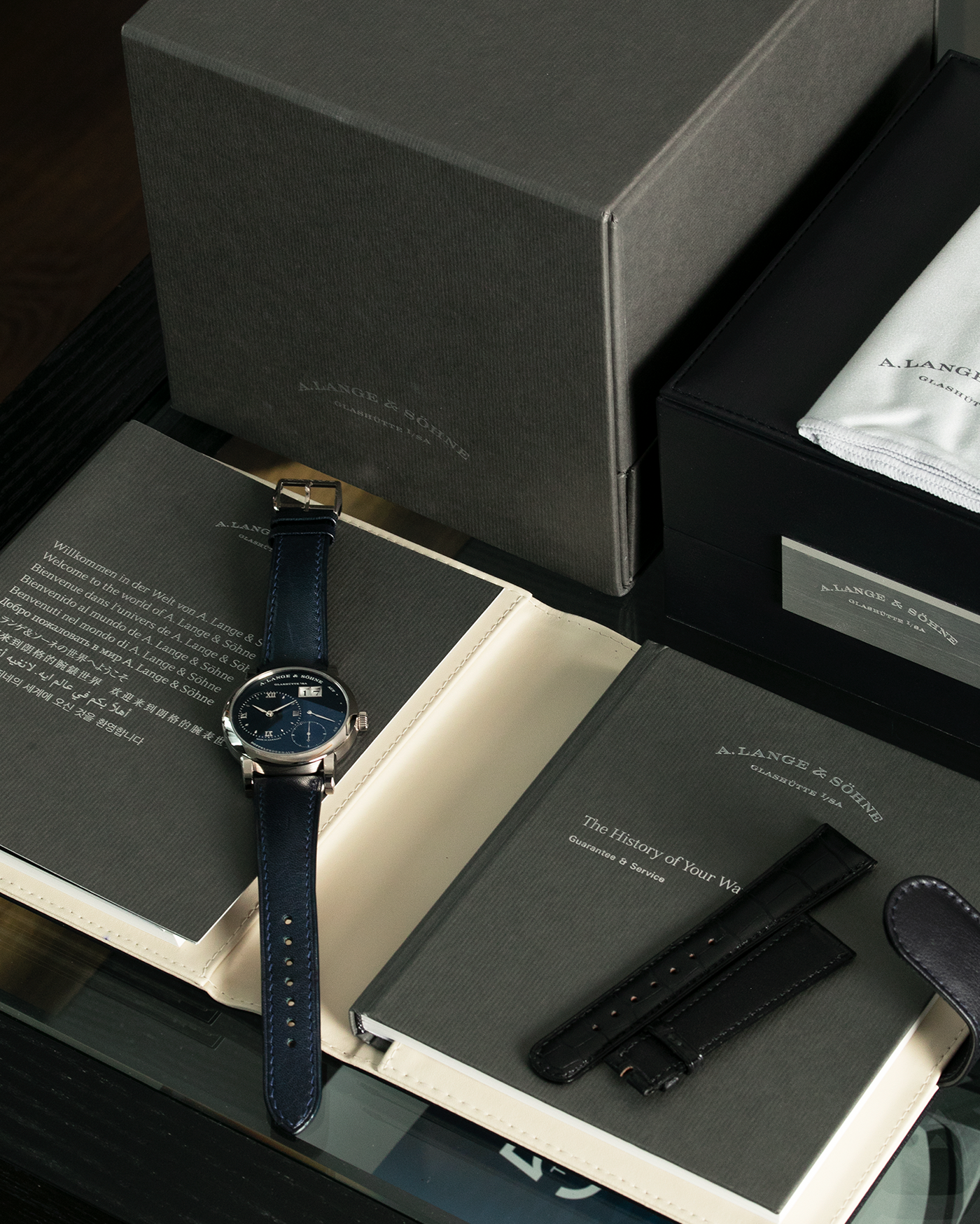 Brand: A. Lange & Söhne Year: 2017 Model: Lange 1 Reference Number: 191.028 Material: 18-carat White Gold Movement: Cal. L121.1, Manual-Winding Case Diameter: 38.5mm Bracelet/Strap: Dark Blue Calf Strap and A. Lange & Söhne Dark Blue Alligator Leather with Signed Tang Buckle 