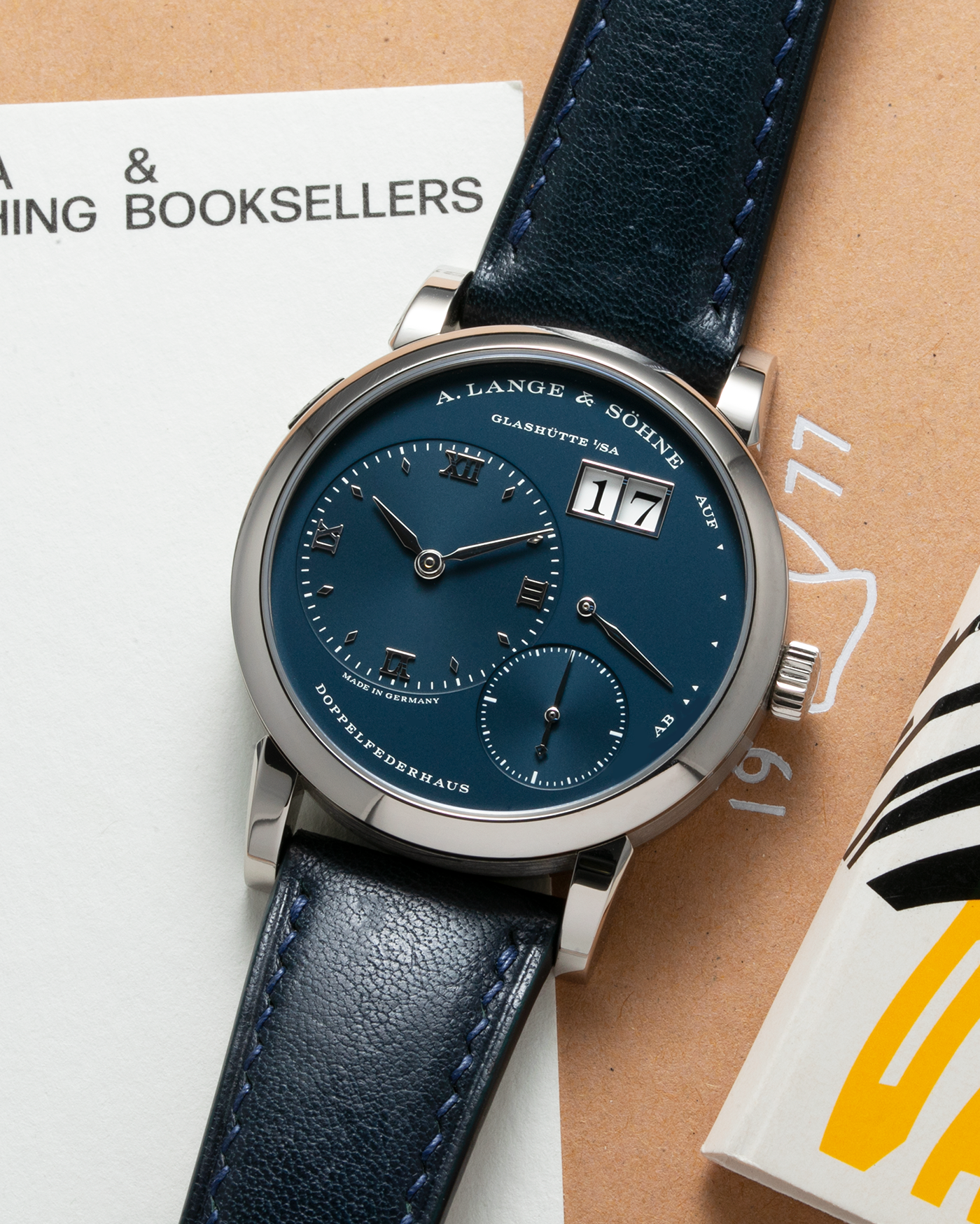 Brand: A. Lange & Söhne Year: 2017 Model: Lange 1 Reference Number: 191.028 Material: 18-carat White Gold Movement: Cal. L121.1, Manual-Winding Case Diameter: 38.5mm Bracelet/Strap: Dark Blue Calf Strap and A. Lange & Söhne Dark Blue Alligator Leather with Signed Tang Buckle 