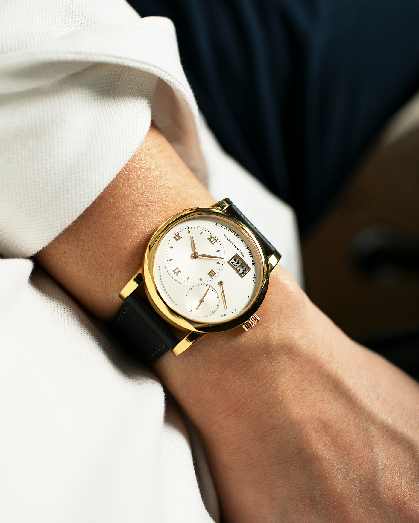 Brand: A. Lange & Söhne Year: 2000’s Model: Lange 1 Reference Number: 101.027 Material: 18-carat Yellow Gold Movement: Cal. L901.0, Manual-Winding Case Diameter: 38.5mm Bracelet/Strap: Molequin Anthracite Textured Calf Strap and A. Lange & Sohne Black Alligator Strap with 18k Yellow Gold Tang Buckle