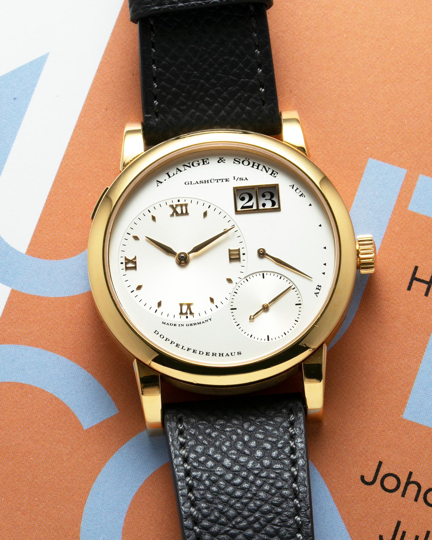 Brand: A. Lange & Söhne Year: 2000’s Model: Lange 1 Reference Number: 101.027 Material: 18-carat Yellow Gold Movement: Cal. L901.0, Manual-Winding Case Diameter: 38.5mm Bracelet/Strap: Molequin Anthracite Textured Calf Strap and A. Lange & Sohne Black Alligator Strap with 18k Yellow Gold Tang Buckle