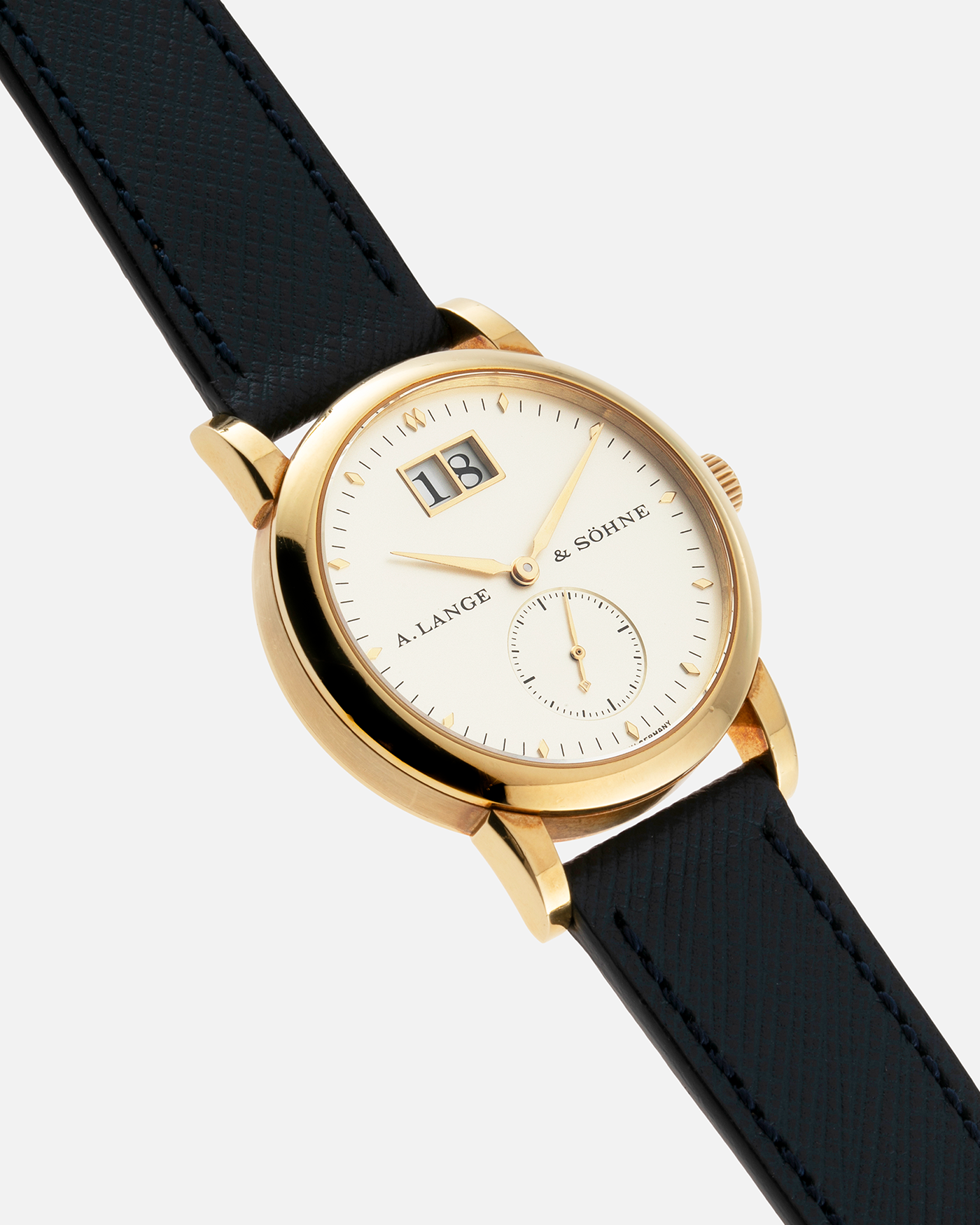 Brand: A. Lange & Sohne Year: Between 1994 - 1996 Model: Saxonia   Reference Number: 102.011 Material: 18-carat Yellow Gold Movement: Cal. L911.3, Manual-Wind Case Diameter: 34mm x 9.1mm Bracelet/Strap: Navy Blue Molequin Textured Leather and A. Lange & Sohne Black Alligator with Signed 18-carat Yellow Gold Tang Buckle