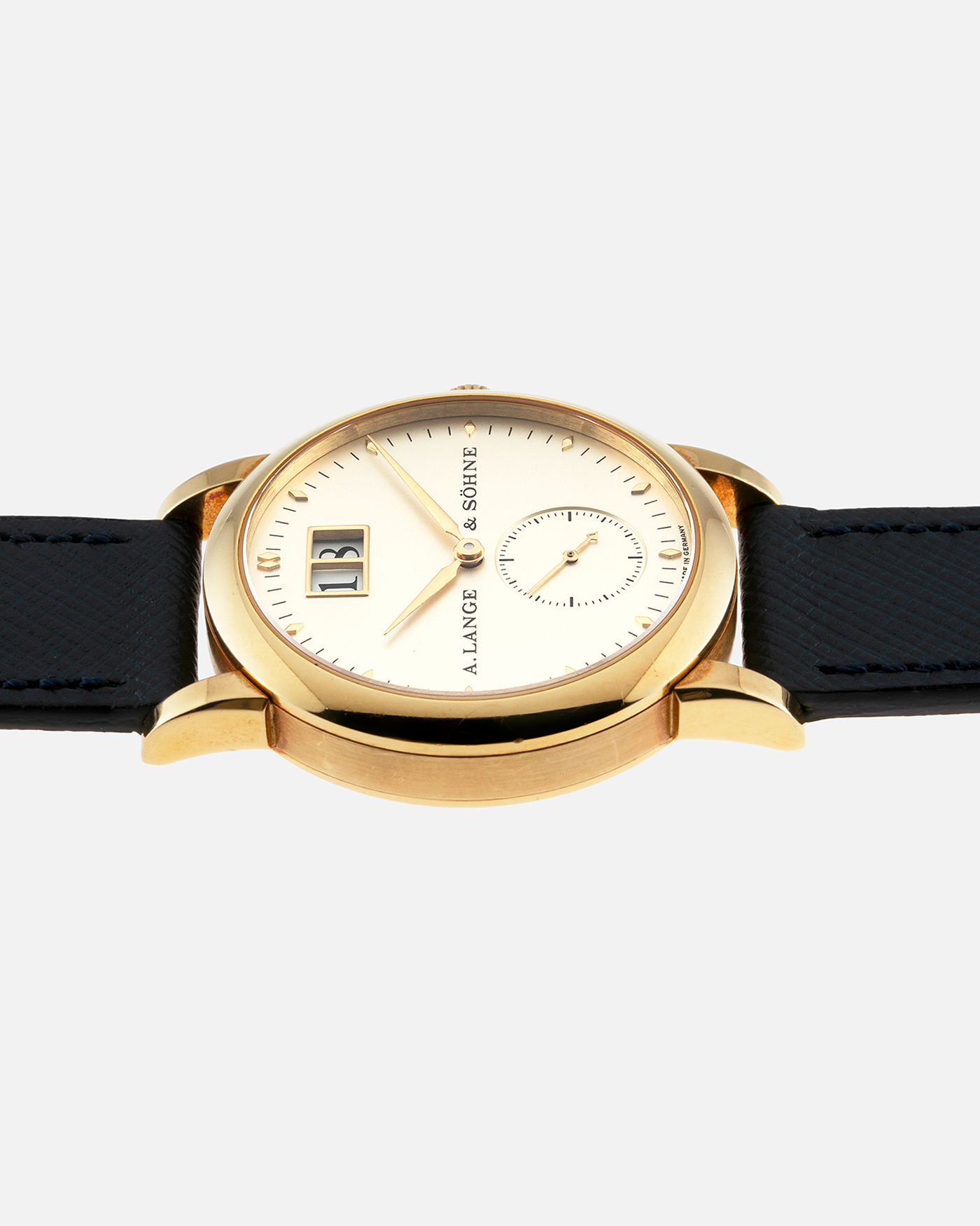 Brand: A. Lange & Sohne Year: Between 1994 - 1996 Model: Saxonia   Reference Number: 102.011 Material: 18-carat Yellow Gold Movement: Cal. L911.3, Manual-Wind Case Diameter: 34mm x 9.1mm Bracelet/Strap: Navy Blue Molequin Textured Leather and A. Lange & Sohne Black Alligator with Signed 18-carat Yellow Gold Tang Buckle