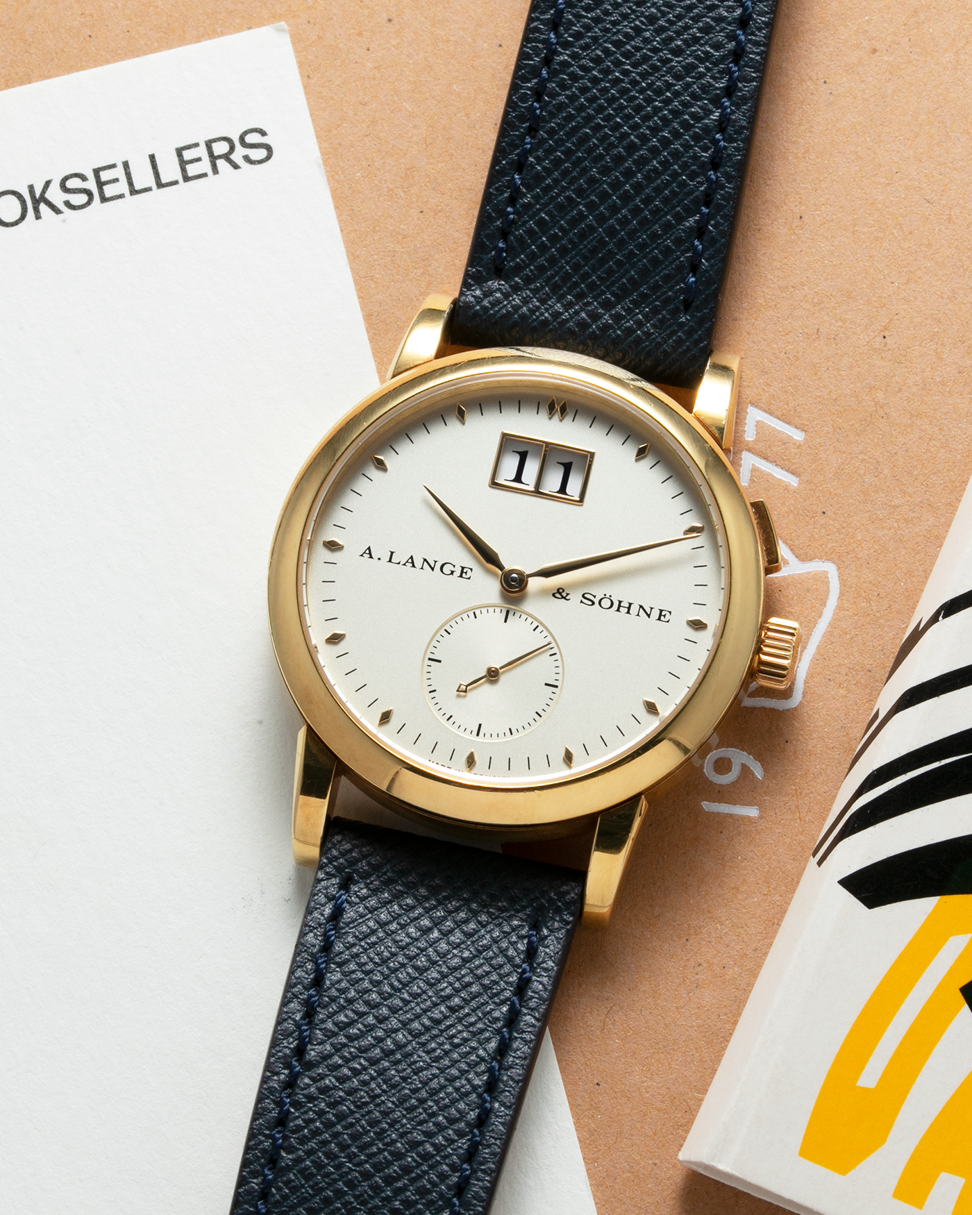Brand: A. Lange & Sohne Year: Between 1994 - 1996 Model: Saxonia   Reference Number: 102.011 Material: 18-carat Yellow Gold Movement: Cal. L911.3, Manual-Wind Case Diameter: 34mm x 9.1mm Bracelet/Strap: Navy Blue Molequin Textured Leather and A. Lange & Sohne Black Alligator with Signed 18-carat Yellow Gold Tang Buckle