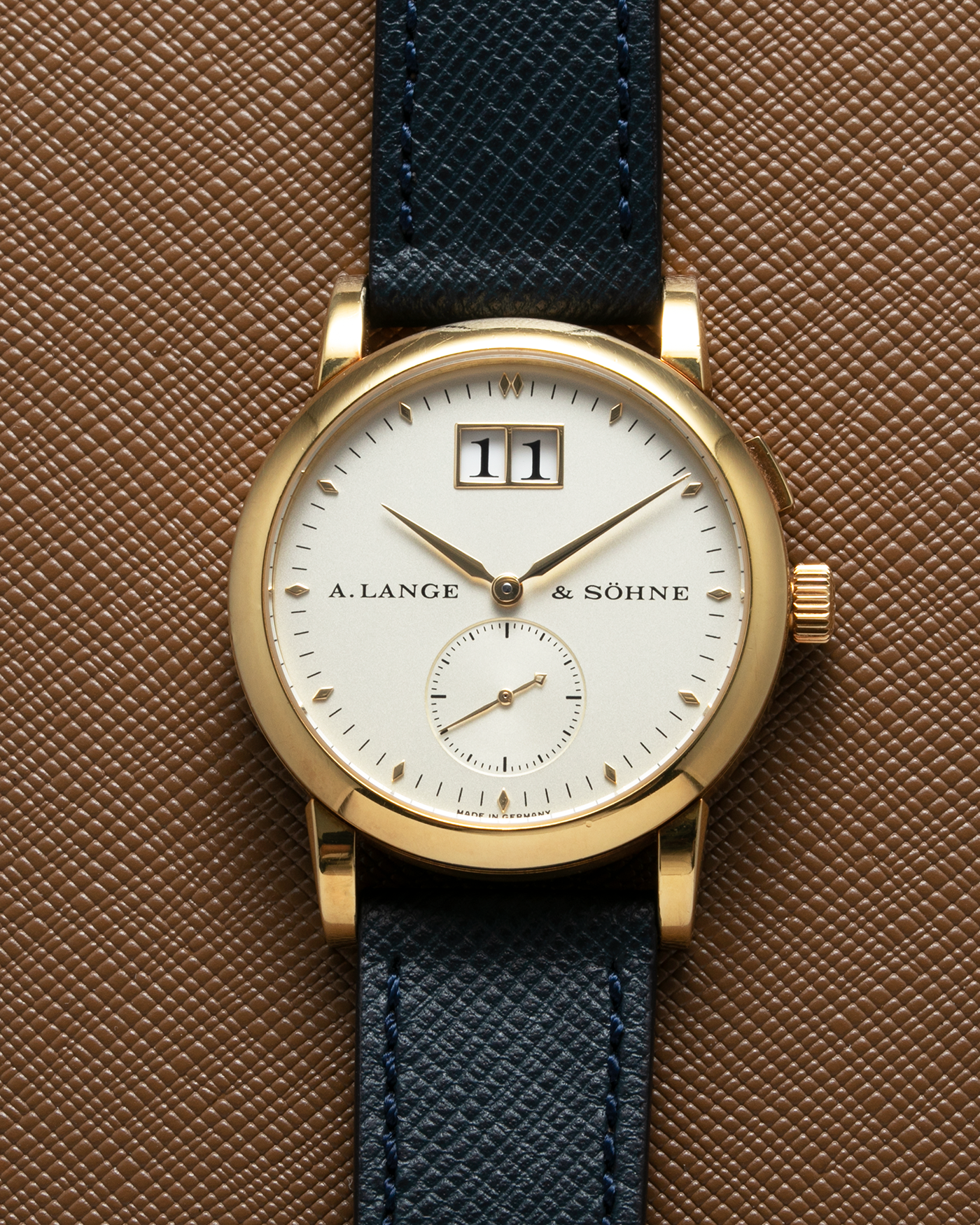 Brand: A. Lange & Sohne Year: Between 1994 - 1996 Model: Saxonia   Reference Number: 102.011 Material: 18-carat Yellow Gold Movement: Cal. L911.3, Manual-Wind Case Diameter: 34mm x 9.1mm Bracelet/Strap: Navy Blue Molequin Textured Leather and A. Lange & Sohne Black Alligator with Signed 18-carat Yellow Gold Tang Buckle