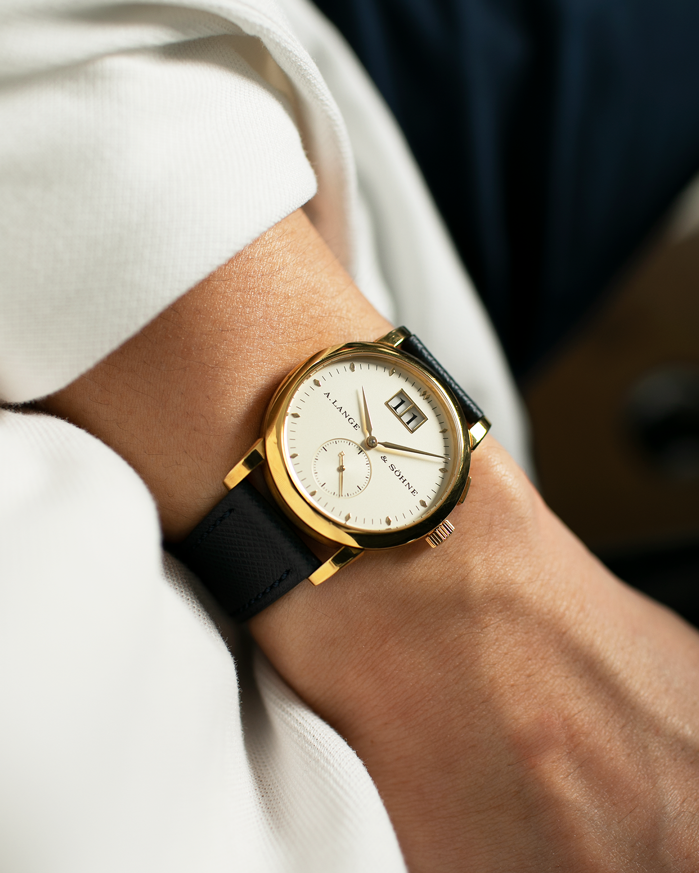 Brand: A. Lange & Sohne Year: Between 1994 - 1996 Model: Saxonia   Reference Number: 102.011 Material: 18-carat Yellow Gold Movement: Cal. L911.3, Manual-Wind Case Diameter: 34mm x 9.1mm Bracelet/Strap: Navy Blue Molequin Textured Leather and A. Lange & Sohne Black Alligator with Signed 18-carat Yellow Gold Tang Buckle
