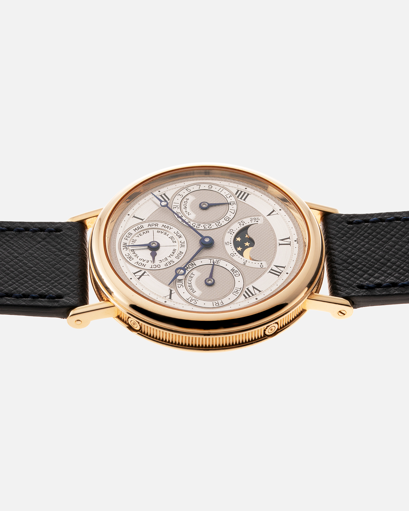 Brand: Breguet Year: 1990’s Model: 3050 Perpetual Calendar Material: 18k Yellow Gold Movement: Breguet Self Winding Perpetual Calendar Case Diameter: 36mm Strap: Molequin Navy Blue Textured Calf with 18k Yellow Gold Breguet Tang Buckle