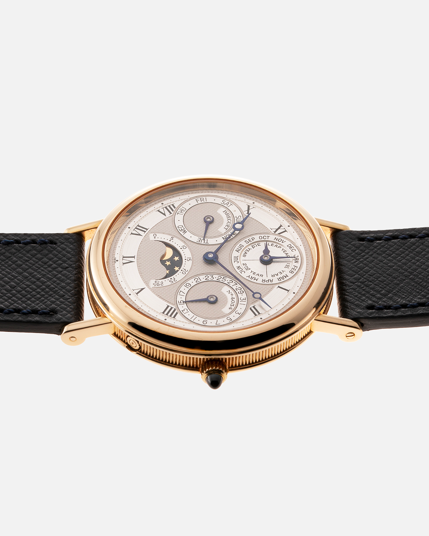 Brand: Breguet Year: 1990’s Model: 3050 Perpetual Calendar Material: 18k Yellow Gold Movement: Breguet Self Winding Perpetual Calendar Case Diameter: 36mm Strap: Molequin Navy Blue Textured Calf with 18k Yellow Gold Breguet Tang Buckle