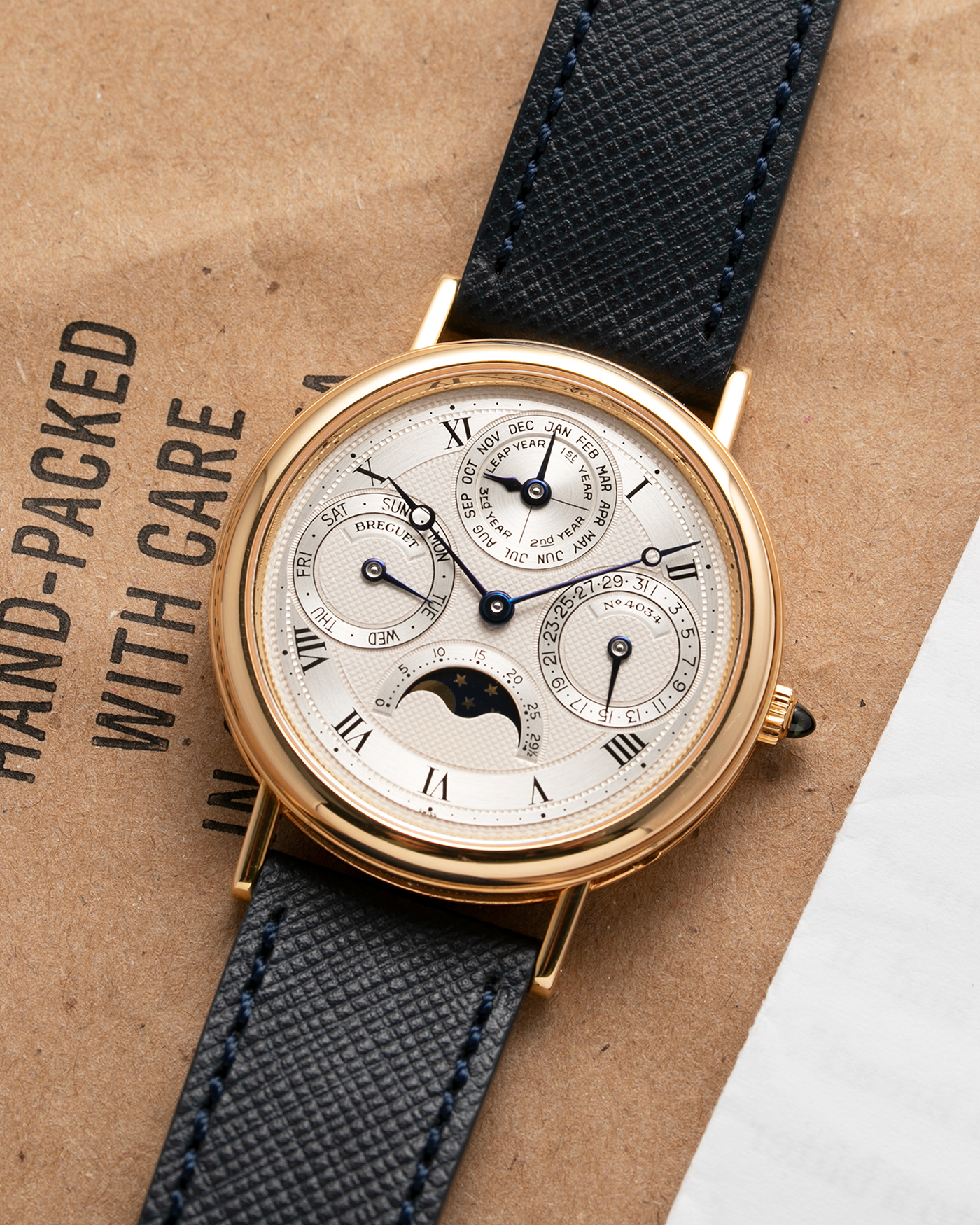 Brand: Breguet Year: 1990’s Model: 3050 Perpetual Calendar Material: 18k Yellow Gold Movement: Breguet Self Winding Perpetual Calendar Case Diameter: 36mm Strap: Molequin Navy Blue Textured Calf with 18k Yellow Gold Breguet Tang Buckle