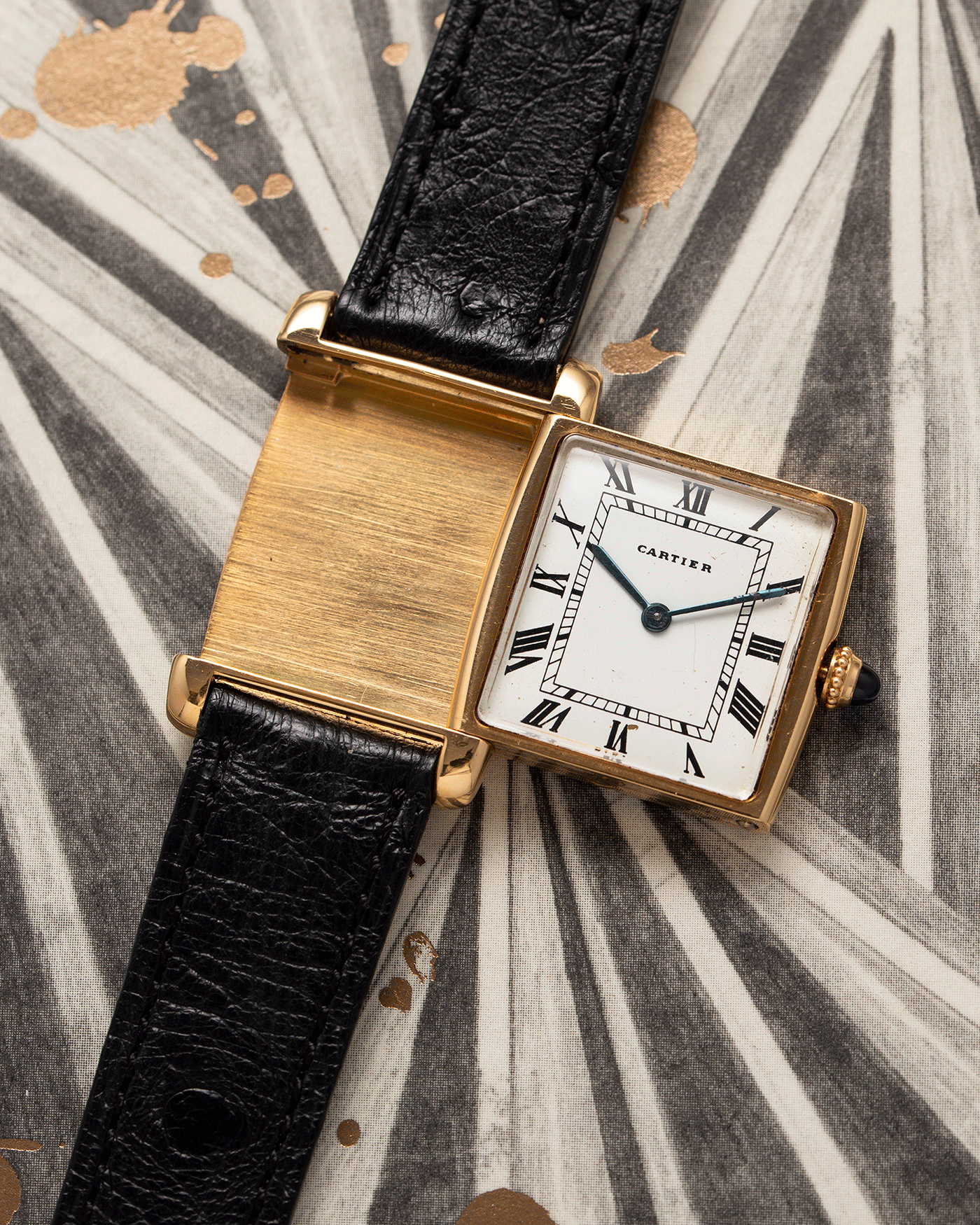 Brand: Cartier Year: 1970s Model: Tank ‘Reverso’ Material: 18k Yellow Gold Movement: Manual-winding caliber 610  Case Diameter: 32mm X 23mm Lug Width: 16mm Bracelet/Strap: Black Leather Strap and 18k Cartier Yellow Gold Deployant