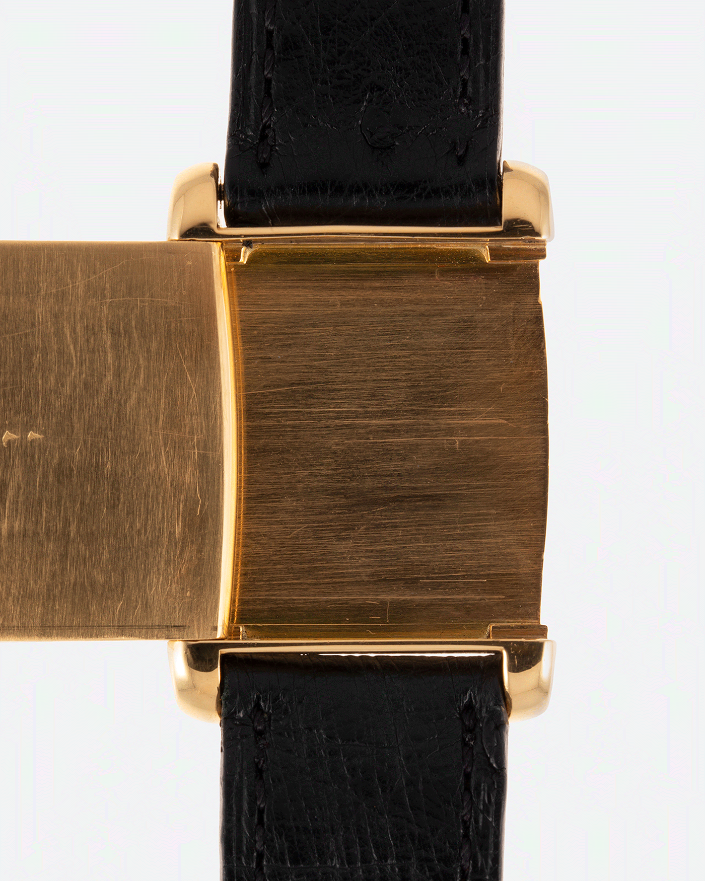 Brand: Cartier Year: 1970s Model: Tank ‘Reverso’ Material: 18k Yellow Gold Movement: Manual-winding caliber 610  Case Diameter: 32mm X 23mm Lug Width: 16mm Bracelet/Strap: Black Leather Strap and 18k Cartier Yellow Gold Deployant