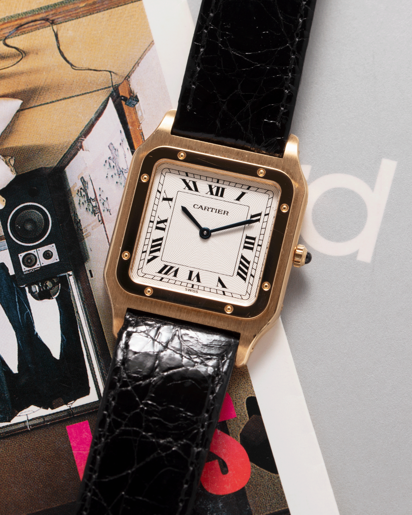 Brand: Cartier Year: 1990s Model: Santos Dumont Reference: 1576 Material: 18k Yellow Gold Movement: F.Piguet 21 Case Diameter: 27mm Strap: Black Leather Strap with Cartier 18k Yellow Gold Tang Buckle