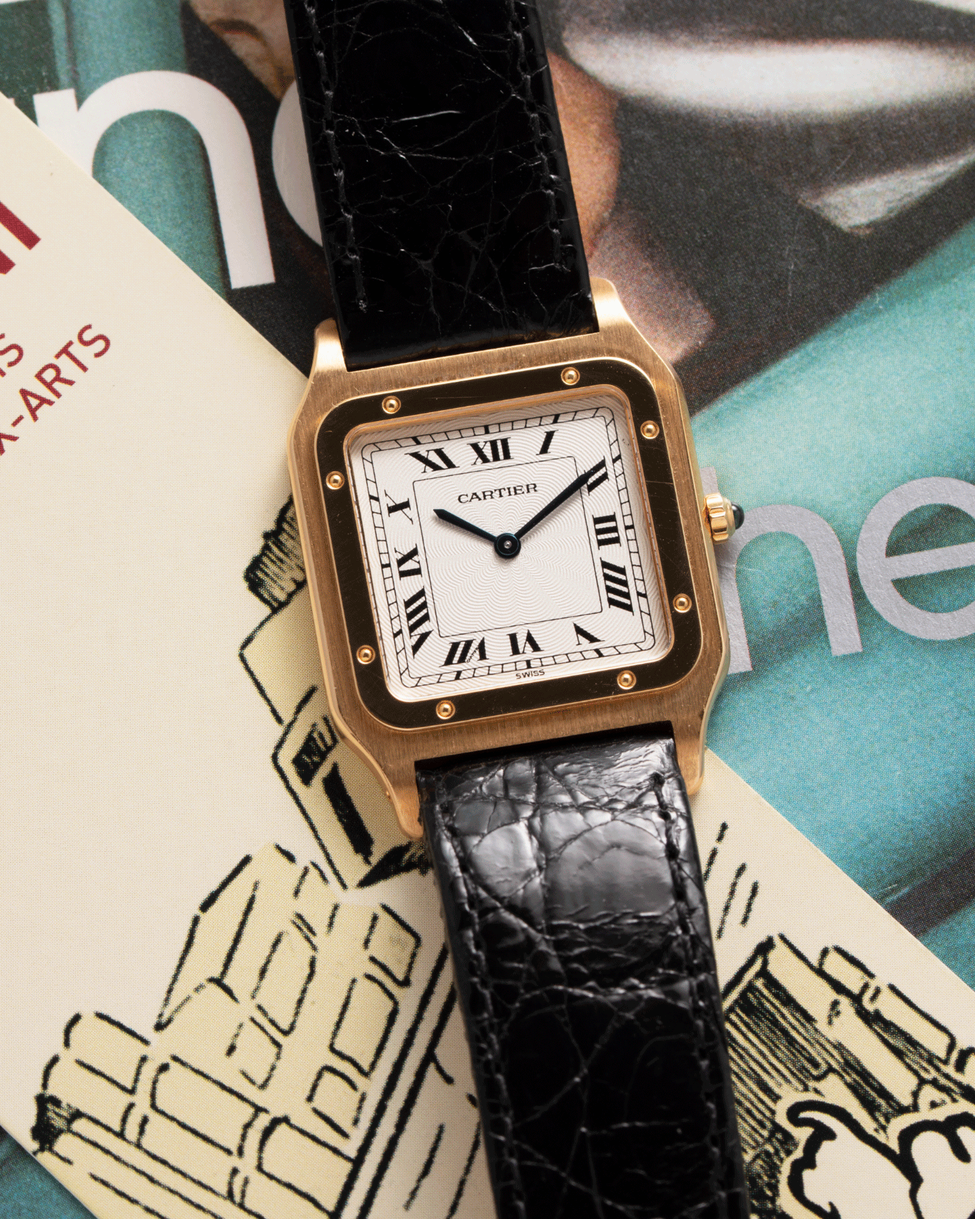 Brand: Cartier Year: 1990s Model: Santos Dumont Reference: 1576 Material: 18k Yellow Gold Movement: F.Piguet 21 Case Diameter: 27mm Strap: Black Leather Strap with Cartier 18k Yellow Gold Tang Buckle