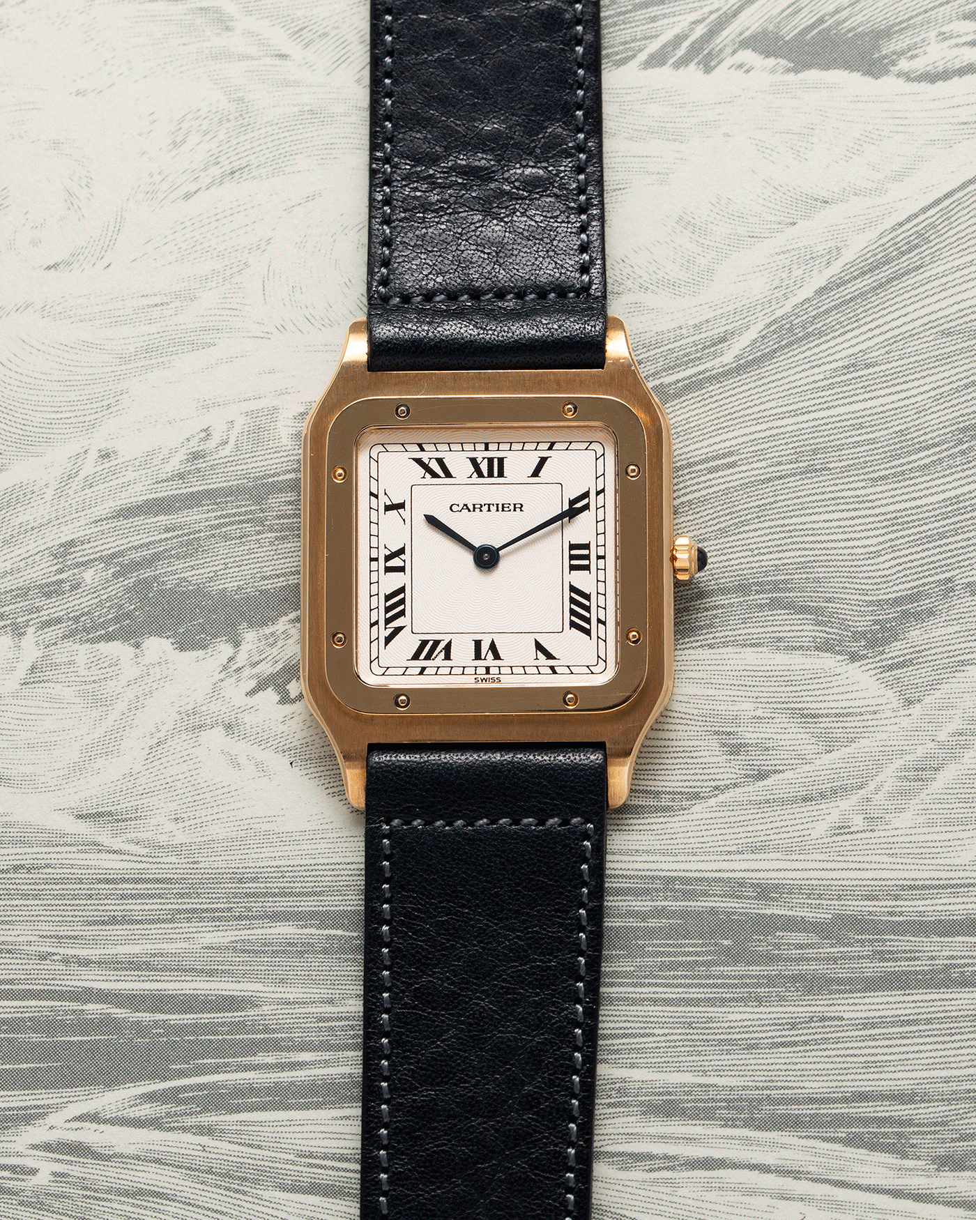 Brand: Cartier Year: 1990s Model: Santos Dumont Reference: 1576 Material: 18k Yellow Gold Movement: F.Piguet 21 Case Diameter: 27mm Strap: Accurate Form Navy Blue Japanese Calf and 18k Yellow Gold Cartier Deployant