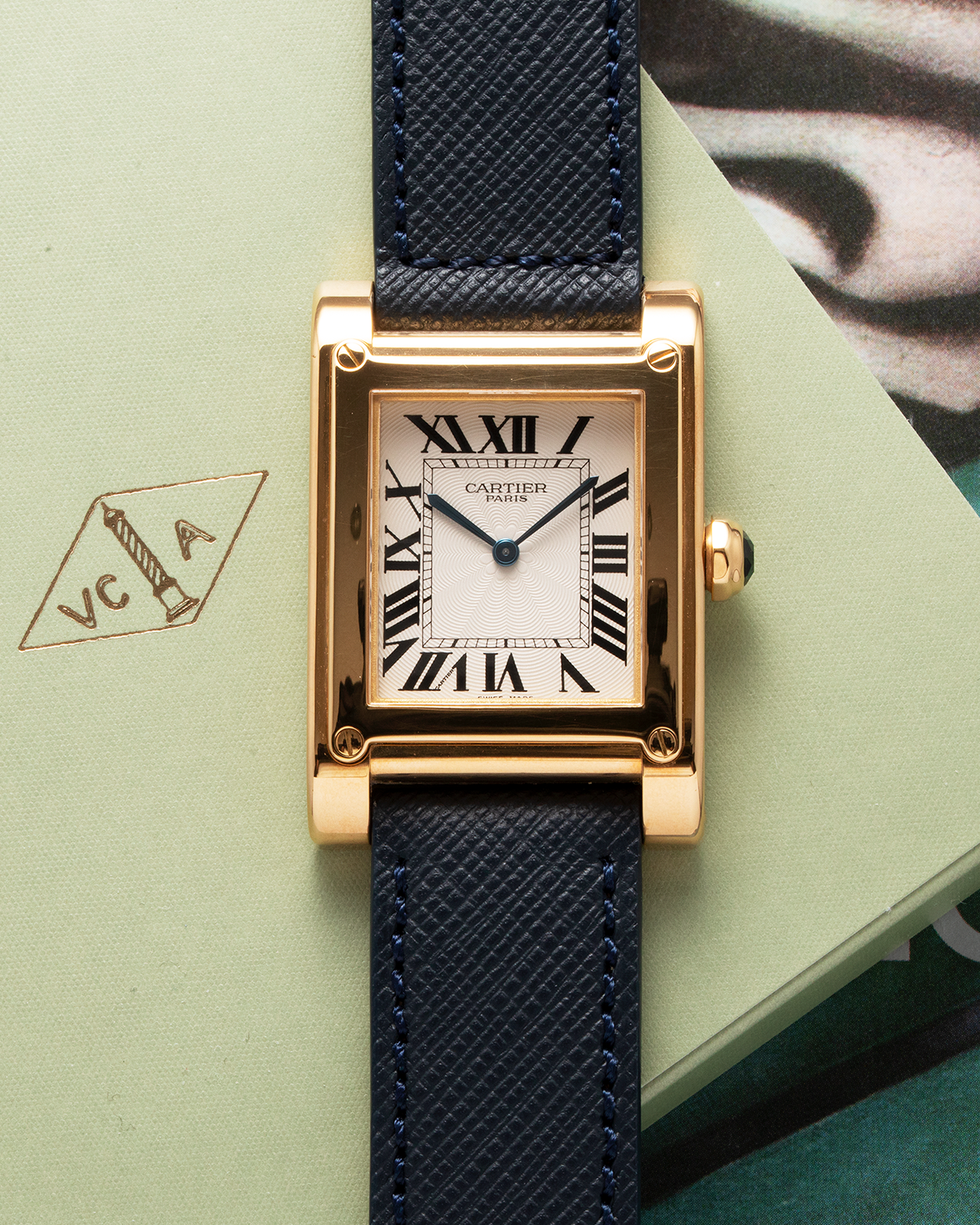 Brand: Cartier Year: 2000’s Model: Tank A Vis Material: 18k Yellow Gold Movement: Cartier 437MC Case Diameter: 26mm X 39mm Strap: Molequin Navy Blue Textured Calf and 18k Yellow Gold Deployant Clasp