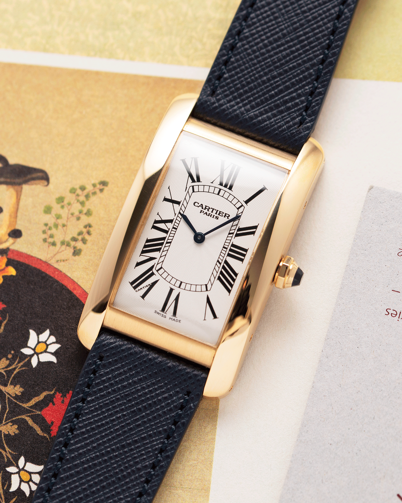 Brand: Cartier Year: 1990s Model: CPCP Collection Prive Tank Americaine Reference: 1735 Material: 18k Yellow Gold Movement: Cartier Caliber 430 MC Case Diameter: 45mm X26mm Strap: Navy Blue Molequin Textured Calf Strap with separate 18k Cartier Yellow Gold Deployant
