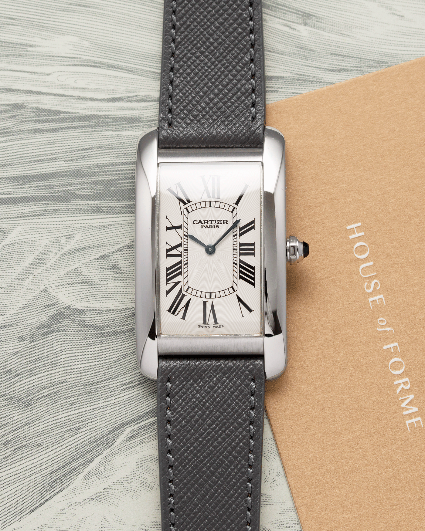 Brand: Cartier Year: 2007 Model: CPCP Collection Prive Tank Americaine Reference: 1734 Material: Platinum Movement: Cartier Caliber 430 MC Case Diameter: 45mm X26mm Strap: Grey Molequin Textured Calf Strap with separate White Gold Cartier Tang Buckle