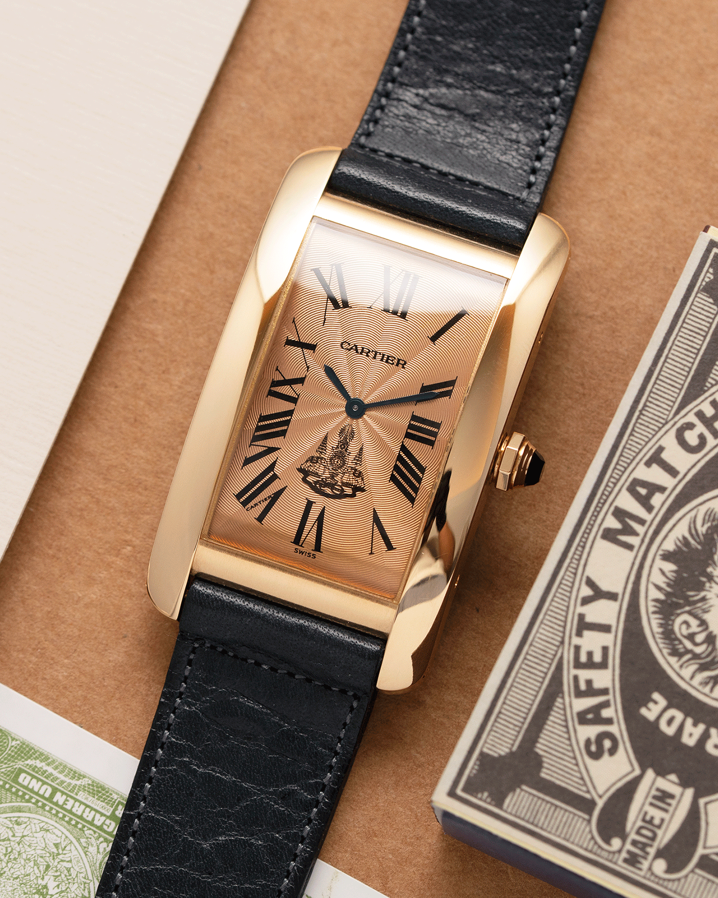 Brand: Cartier Year: 1996 Model: Tank Americaine ‘Thai King’ Reference: 1735 Material: 18k Yellow Gold Movement: Cartier Caliber 430 MC Case Diameter: 45mm X26mm Strap: Navy Blue Accurate Form Calf Strap with separate 18k Cartier Yellow Gold Deployant