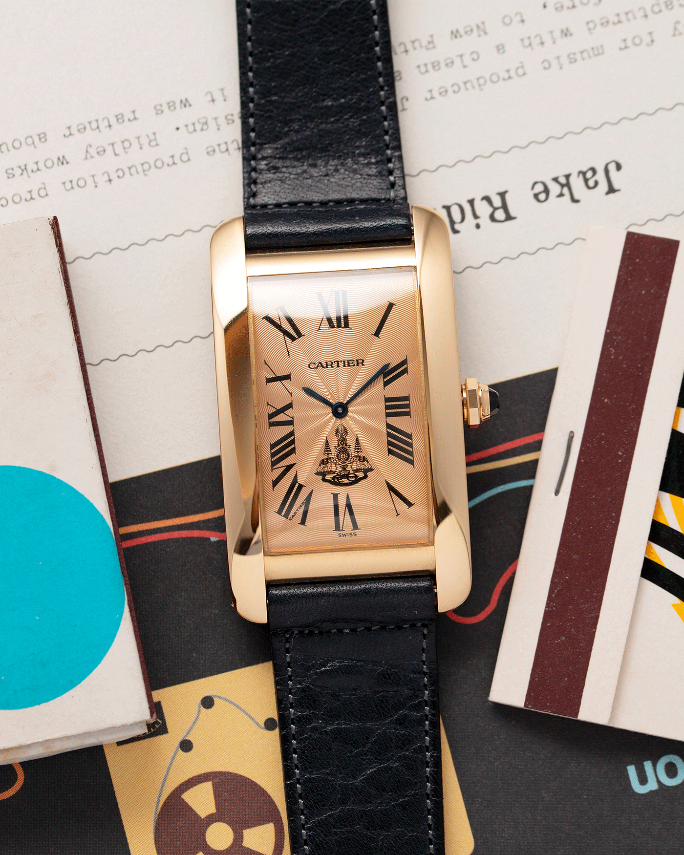 Brand: Cartier Year: 1996 Model: Tank Americaine ‘Thai King’ Reference: 1735 Material: 18k Yellow Gold Movement: Cartier Caliber 430 MC Case Diameter: 45mm X26mm Strap: Navy Blue Accurate Form Calf Strap with separate 18k Cartier Yellow Gold Deployant