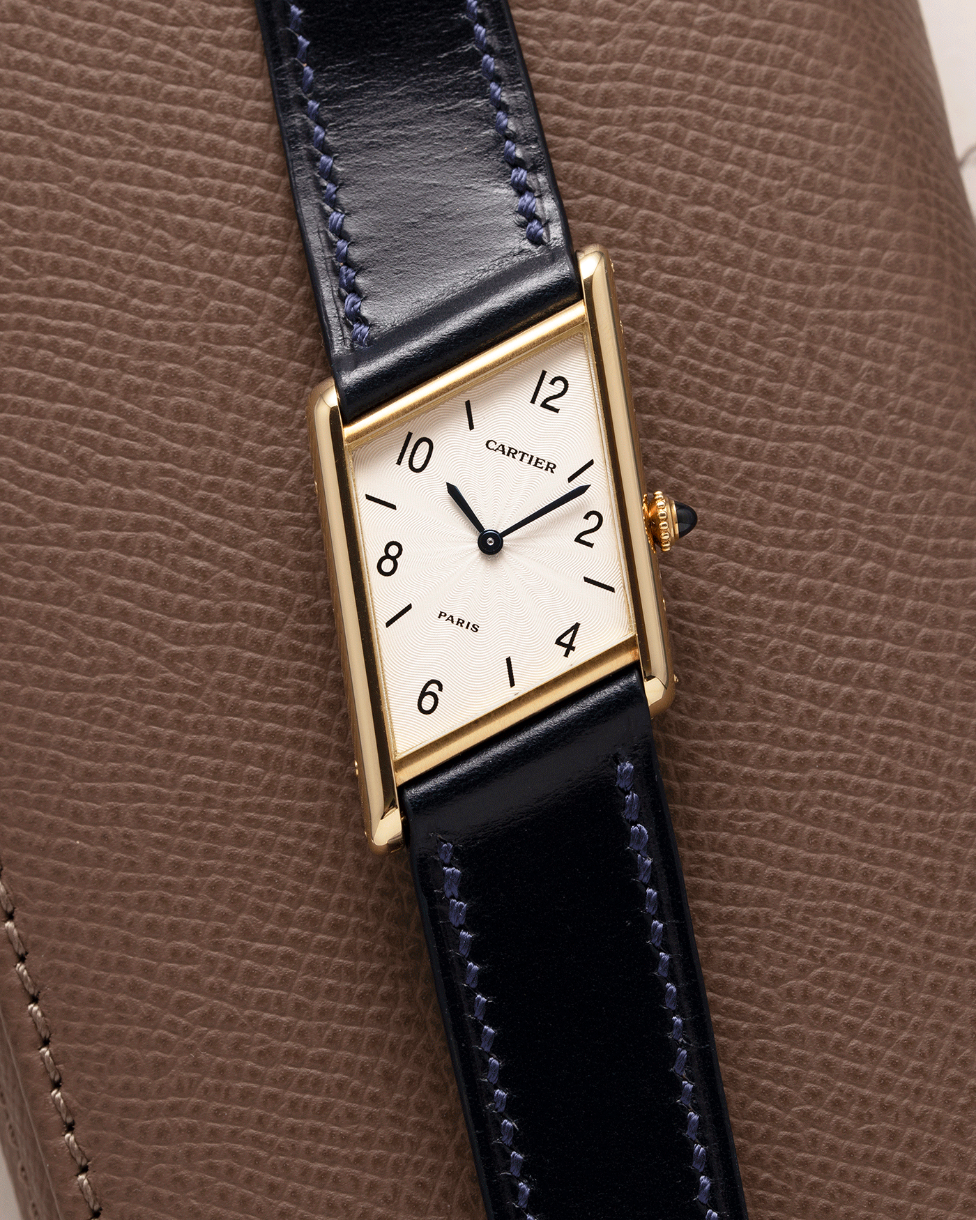 Brand: Cartier Year: 1996 Model: Tank Asymmetrique Limited Reference Number: 2488 Material: 18k Yellow Gold Movement: Cartier Cal. 9P2 Case Diameter: 23mm X 33mm Strap: Nostime Blue Leather with 18k Cartier Yellow Gold Deployant
