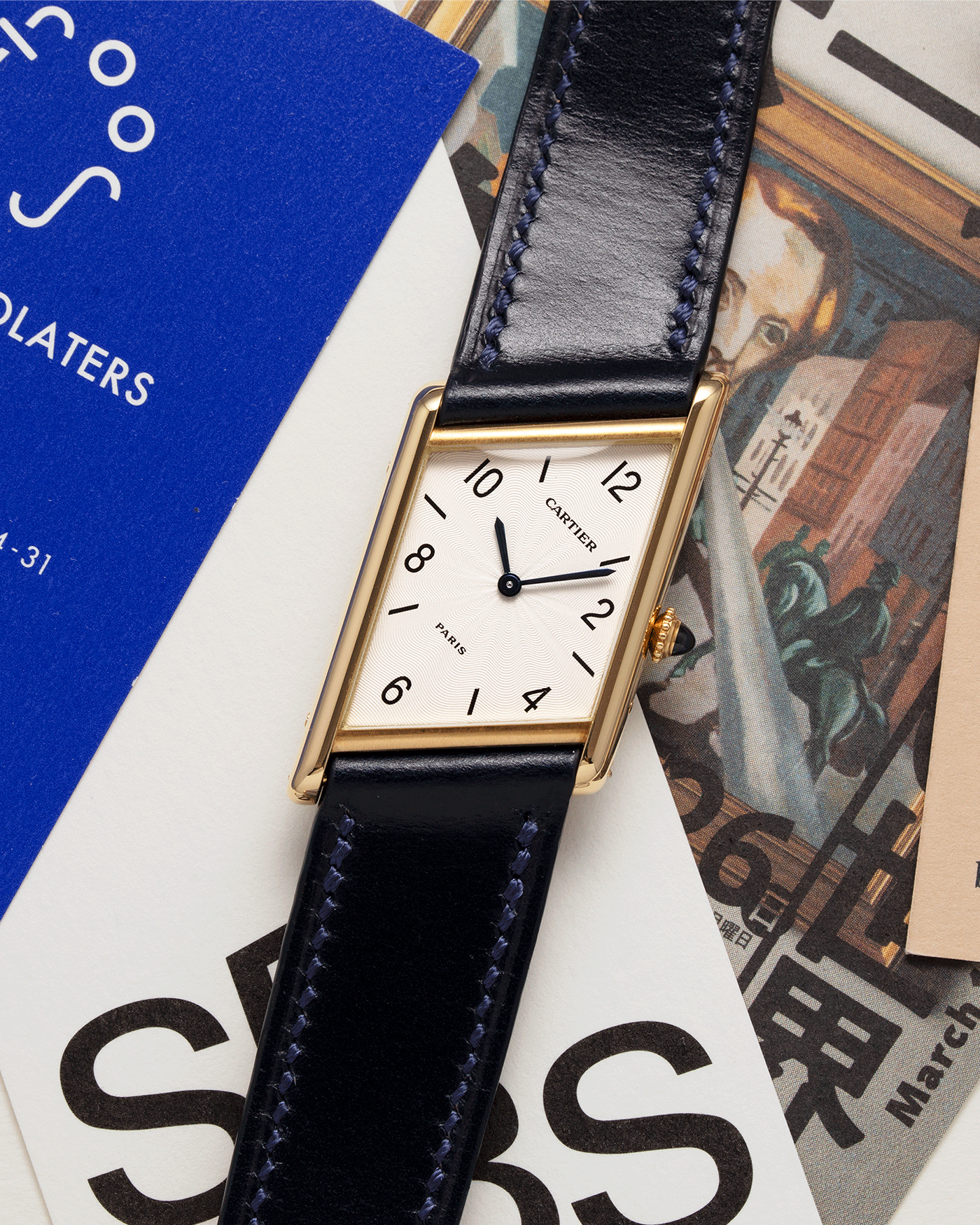 Brand: Cartier Year: 1996 Model: Tank Asymmetrique Limited Reference Number: 2488 Material: 18k Yellow Gold Movement: Cartier Cal. 9P2 Case Diameter: 23mm X 33mm Strap: Nostime Blue Leather with 18k Cartier Yellow Gold Deployant