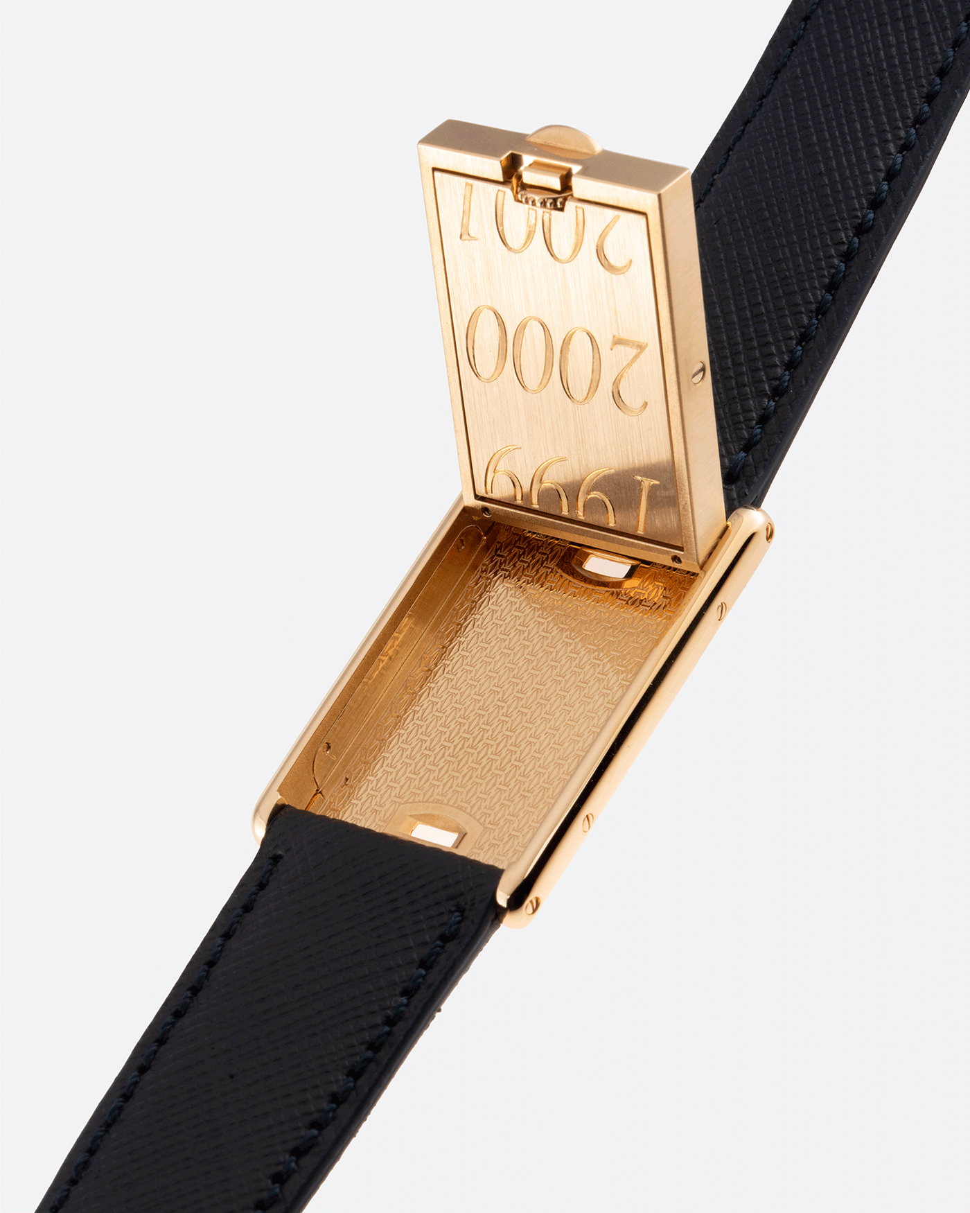 Brand: Cartier Year: 2000 Model: Tank Basculante Material: 18k Yellow Gold Movement: Cartier Cal. 610 (F. Piguet) Case Diameter: 25mm x 39mm Strap: Molequin Navy Blue Textured Calf and 18k Yellow Gold Deployant Clasp