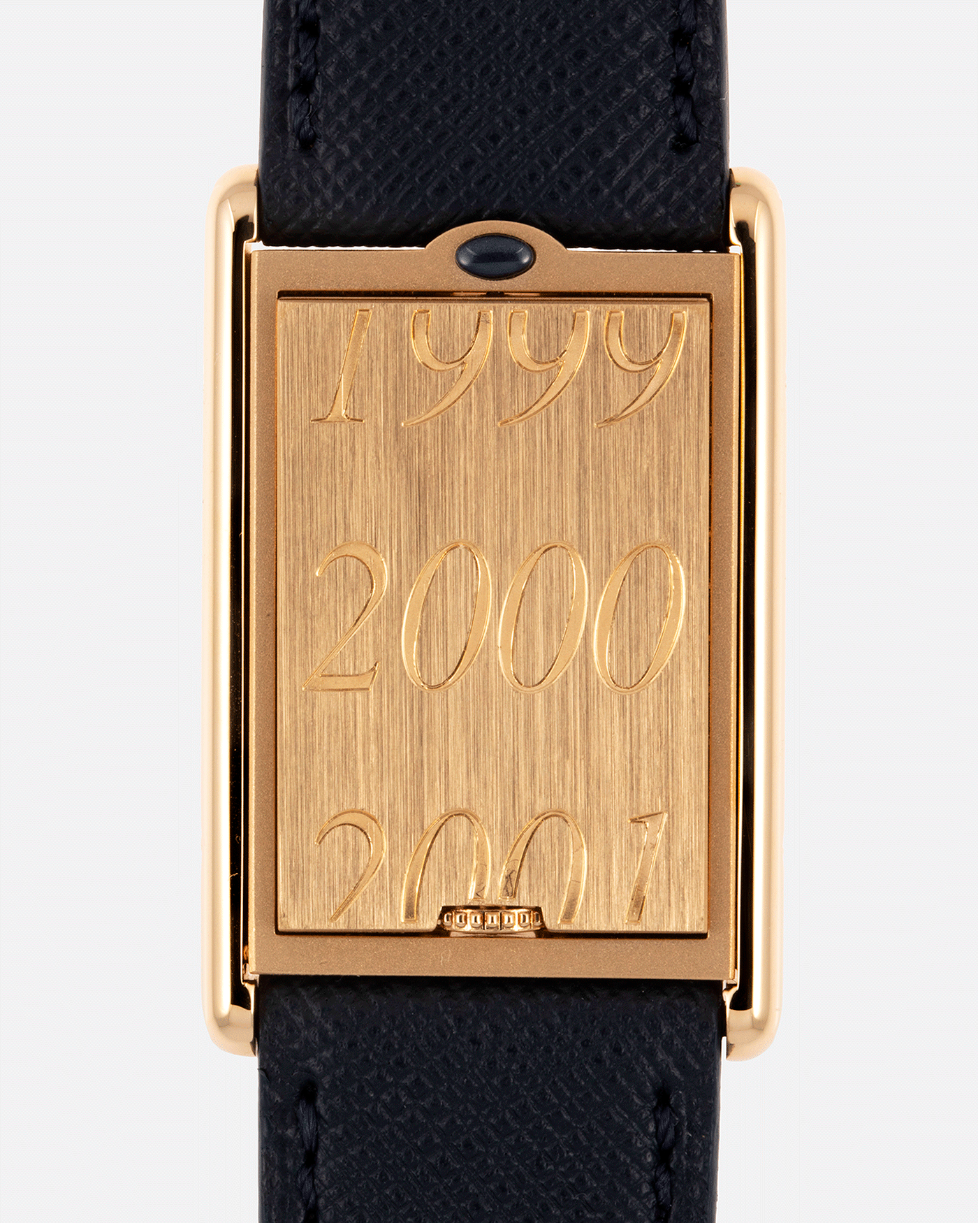 Brand: Cartier Year: 2000 Model: Tank Basculante Material: 18k Yellow Gold Movement: Cartier Cal. 610 (F. Piguet) Case Diameter: 25mm x 39mm Strap: Molequin Navy Blue Textured Calf and 18k Yellow Gold Deployant Clasp