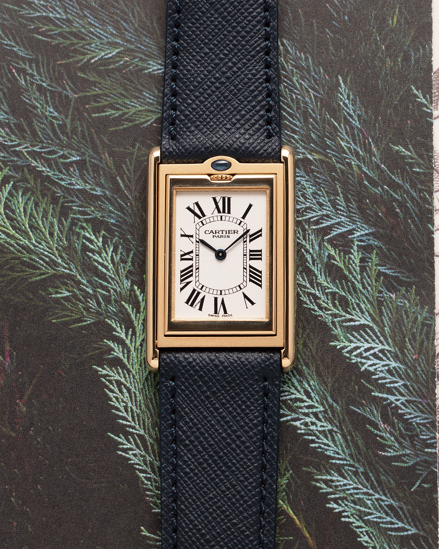 Brand: Cartier Year: 2000 Model: Tank Basculante Material: 18k Yellow Gold Movement: Cartier Cal. 610 (F. Piguet) Case Diameter: 25mm x 39mm Strap: Molequin Navy Blue Textured Calf and 18k Yellow Gold Deployant Clasp