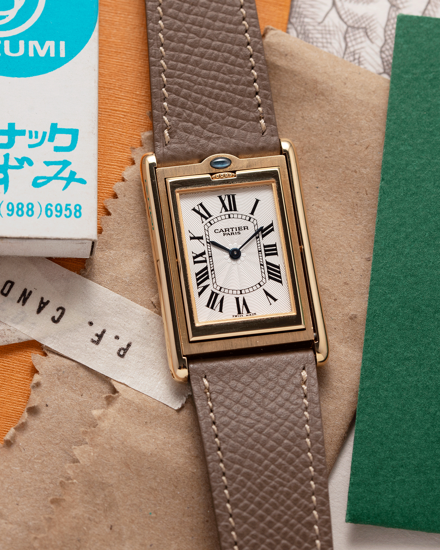 Brand: Cartier Year: 2001 Model: Tank Basculante Material: 18k Yellow Gold Movement: Cartier Cal. 610 (F. Piguet) Case Diameter: 25mm x 39mm Strap: Nostime Taupe Textured Calf and 18k Yellow Gold Deployant Clasp