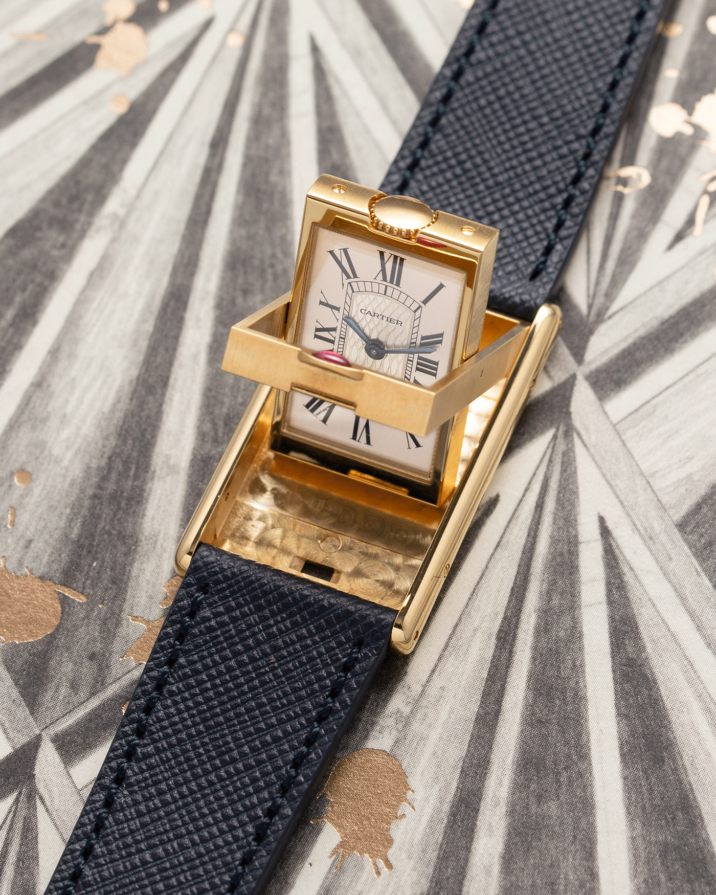 Brand: Cartier Year: 1997 Model: Tank Basculante ‘I Love Cartier’ 150th Anniversary Material: 18k Yellow Gold Movement: Cartier Cal. 610 (F. Piguet) Case Diameter: 22 x 38mm Strap: Navy Blue Molequin Textured Calf Strap with separate 18k Yellow Gold Cartier Tang Buckle