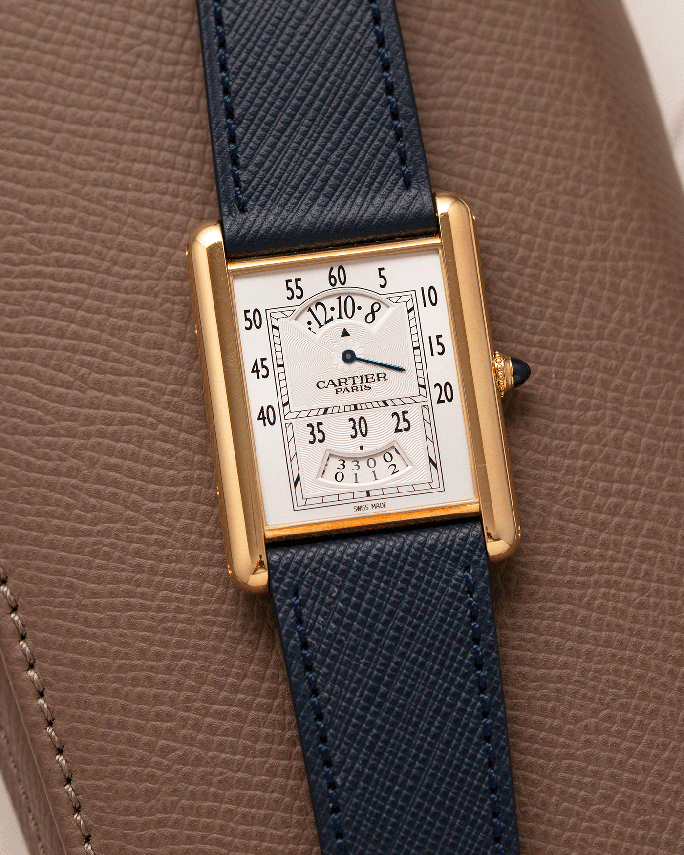 Brand: Cartier Year: 2005 Model: Collection Prive Tank Louis Cartier Wandering Hours Reference: 2918 Material: 18k Rose Gold Movement: Piaget-Based Manually Wound Cal. 9902 MC Case Diameter: 28mm width, 40.5mm lug to lug Strap: Navy Blue Molequin Textured Calf Strap with separate 18k Cartier Rose Gold Deployant