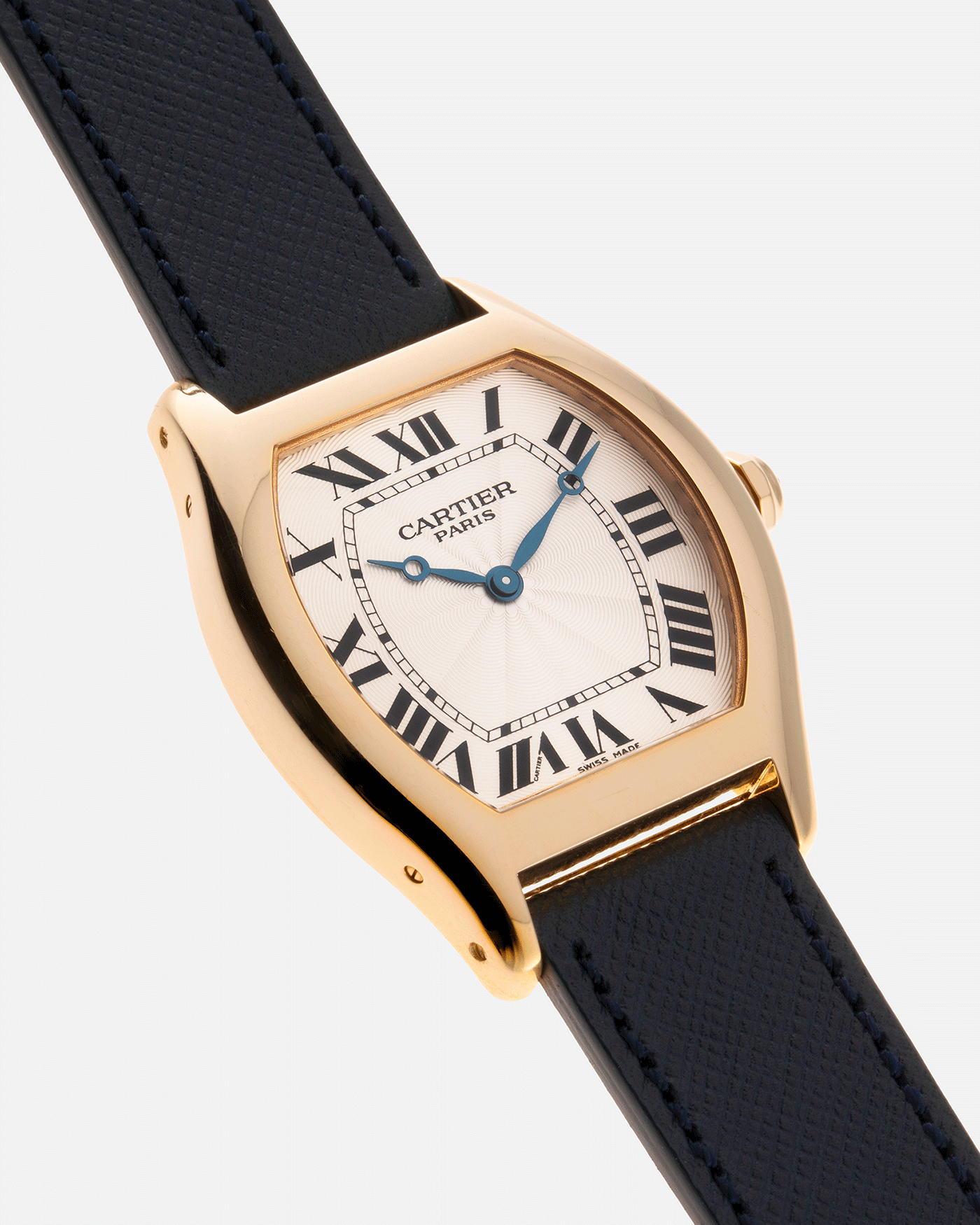 Brand: Cartier Year: 2000’s Model: CPCP Collection Prive Tortue Reference: 2496 Material: 18k Yellow Gold Movement: Cartier Jaeger LeCoultre 9601MC Case Diameter: 43 x 35 mm Strap: Navy Blue Molequin Textured Calf Strap with separate 18k Cartier Yellow Gold Deployant