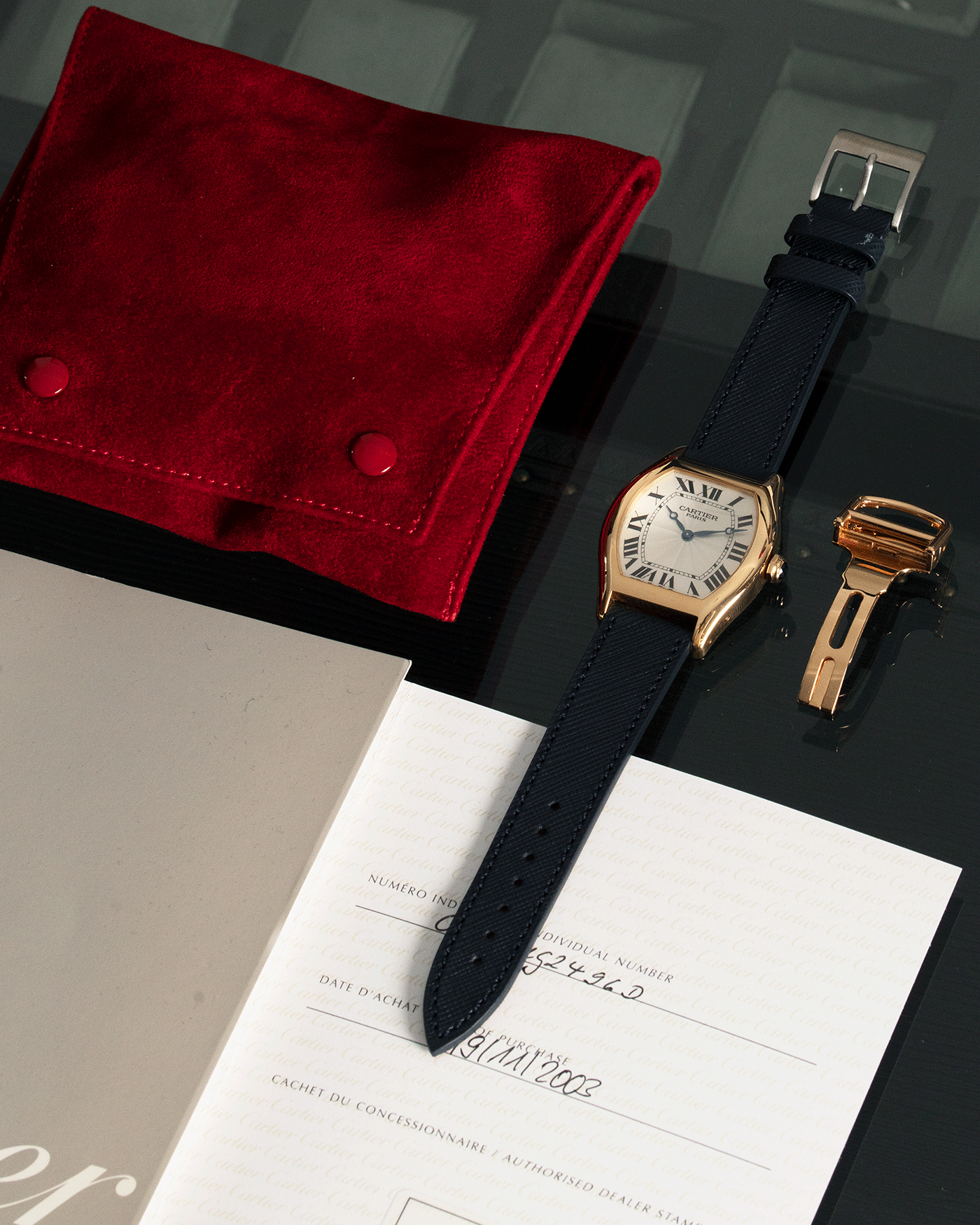 Brand: Cartier Year: 2000’s Model: CPCP Collection Prive Tortue Reference: 2496 Material: 18k Yellow Gold Movement: Cartier Jaeger LeCoultre 9601MC Case Diameter: 43 x 35 mm Strap: Navy Blue Molequin Textured Calf Strap with separate 18k Cartier Yellow Gold Deployant