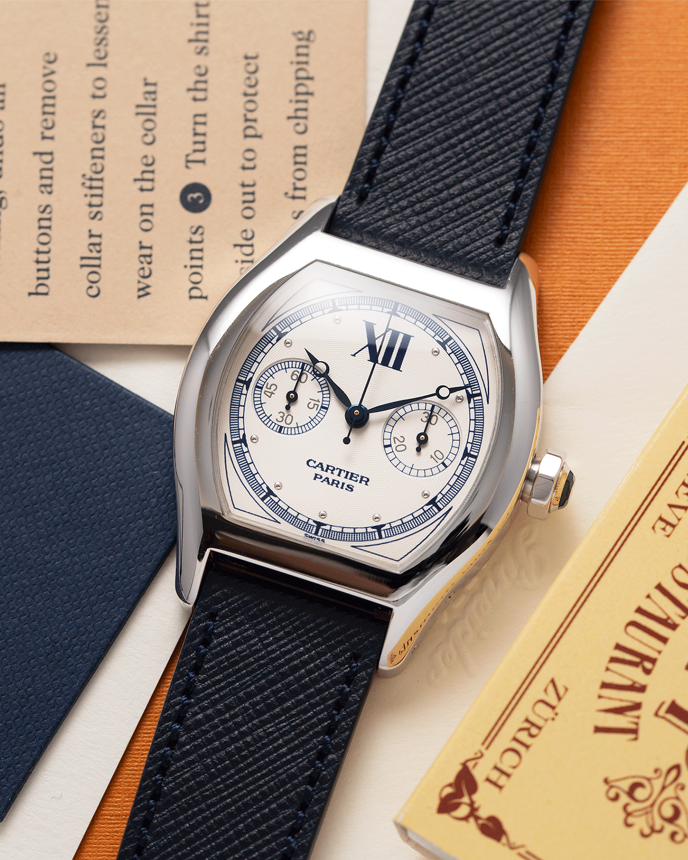Brand: Cartier Year: 2000’s Model: CPCP Collection Prive Tortue Monopoussoir Reference: 2356 Material: 18k White Gold Movement: THA Cal. 045MC Case Diameter: 43 x 35 mm Strap: Navy Blue Molequin Textured Calf Strap with separate 18k Cartier White Gold Deployant