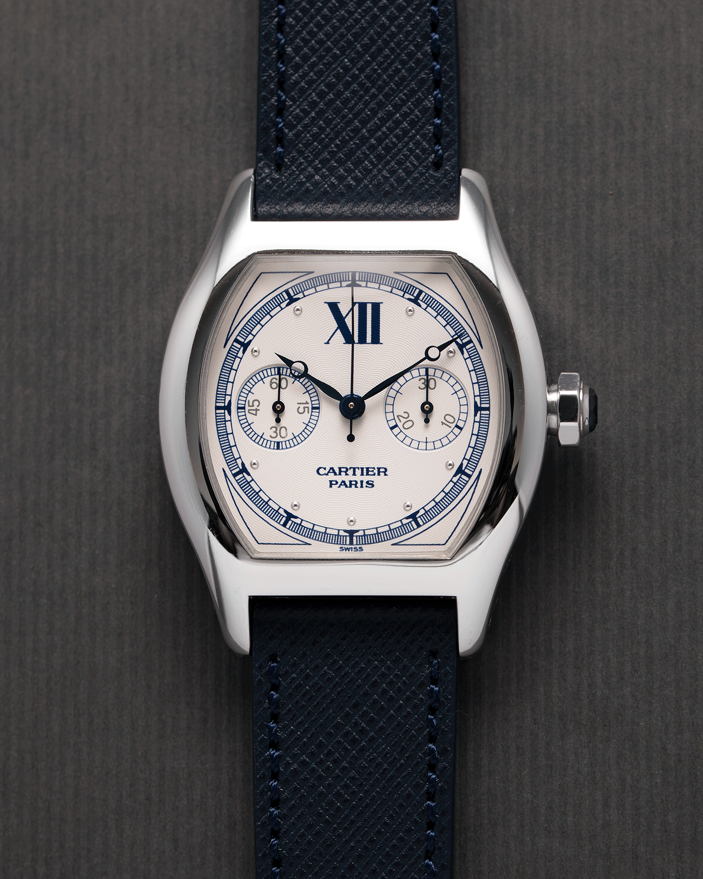Brand: Cartier Year: 2000’s Model: CPCP Collection Prive Tortue Monopoussoir Reference: 2356 Material: 18k White Gold Movement: THA Cal. 045MC Case Diameter: 43 x 35 mm Strap: Navy Blue Molequin Textured Calf Strap with separate 18k Cartier White Gold Deployant