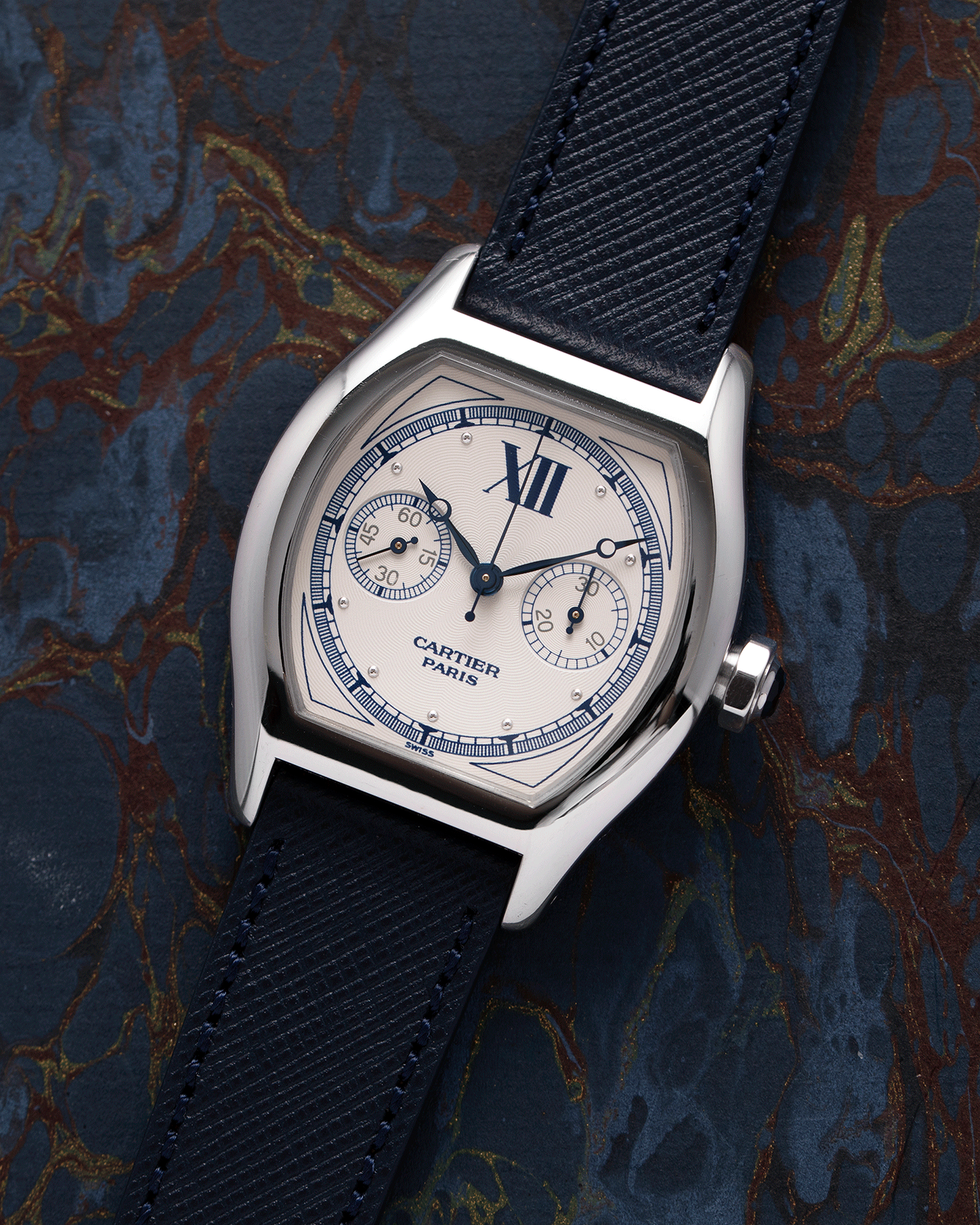 Brand: Cartier Year: 2000’s Model: CPCP Collection Prive Tortue Monopoussoir Reference: 2356 Material: 18k White Gold Movement: THA Cal. 045MC Case Diameter: 43 x 35 mm Strap: Navy Blue Molequin Textured Calf Strap with separate 18k Cartier White Gold Deployant