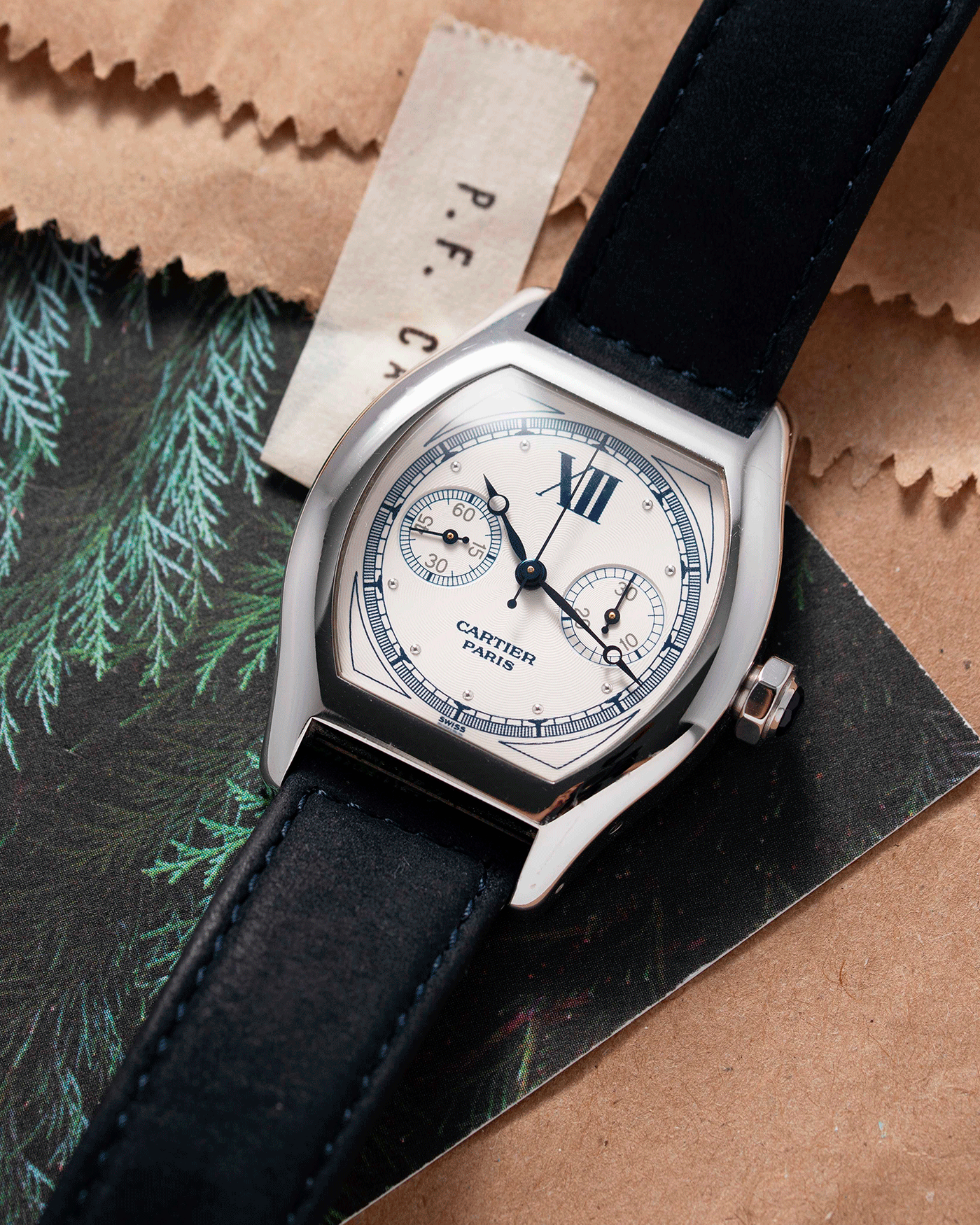 Brand: Cartier Year: 2000’s Model: CPCP Collection Prive Tortue Monopoussoir Reference: 2356 Material: 18k White Gold Movement: THA Cal. 045MC Case Diameter: 43 x 35 mm Strap: Navy Blue Suede Calf Strap with separate 18k Cartier White Gold Deployant