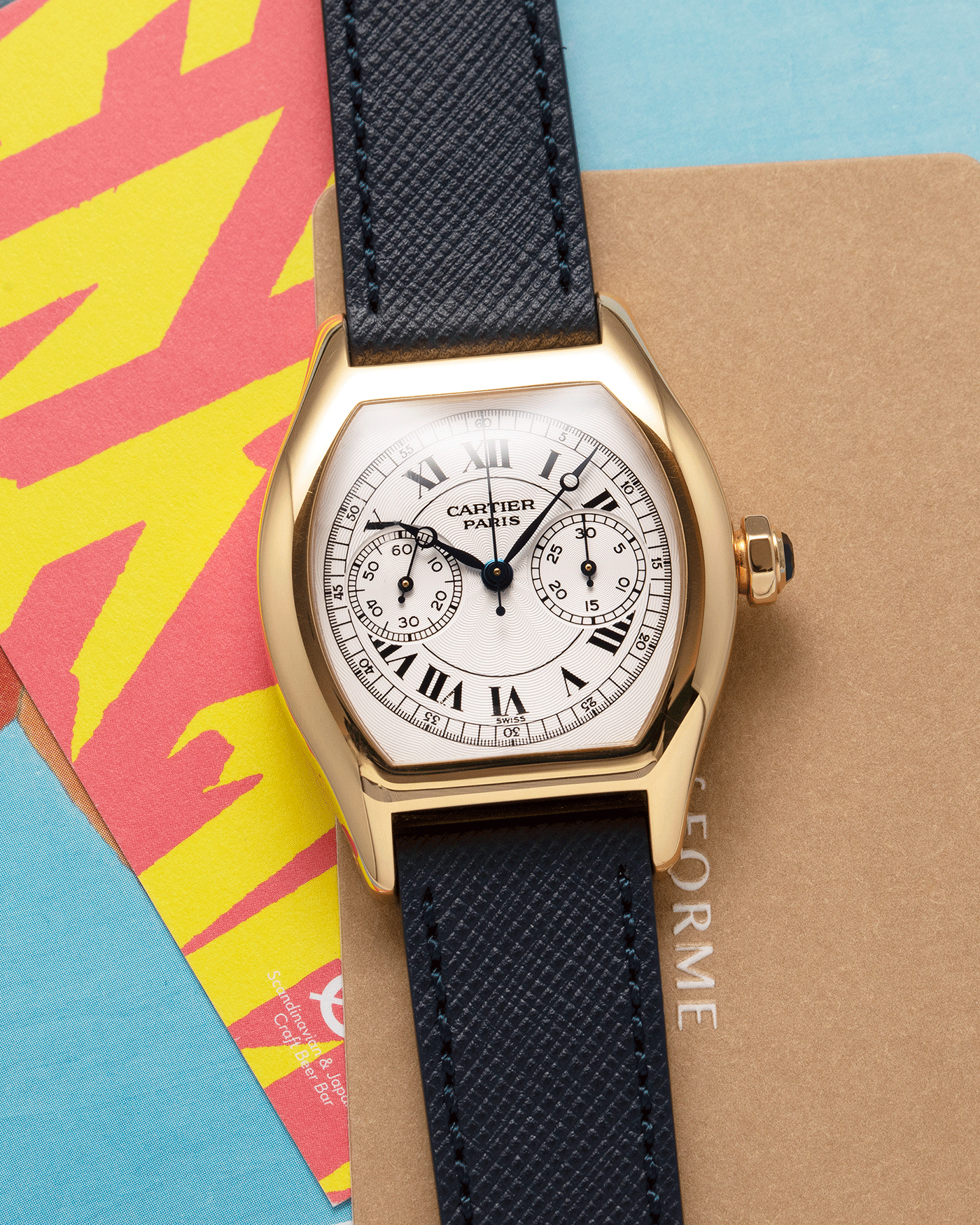 Brand: Cartier Year: 2000’s Model: CPCP Collection Prive Tortue Monopoussoir Reference: 2356E Material: 18k Yellow Gold Movement: THA Cal. 045MC Case Diameter: 43 x 35 mm Strap: Molequin Navy Blue Textured Calf with 18k Cartier Yellow Gold Deployant