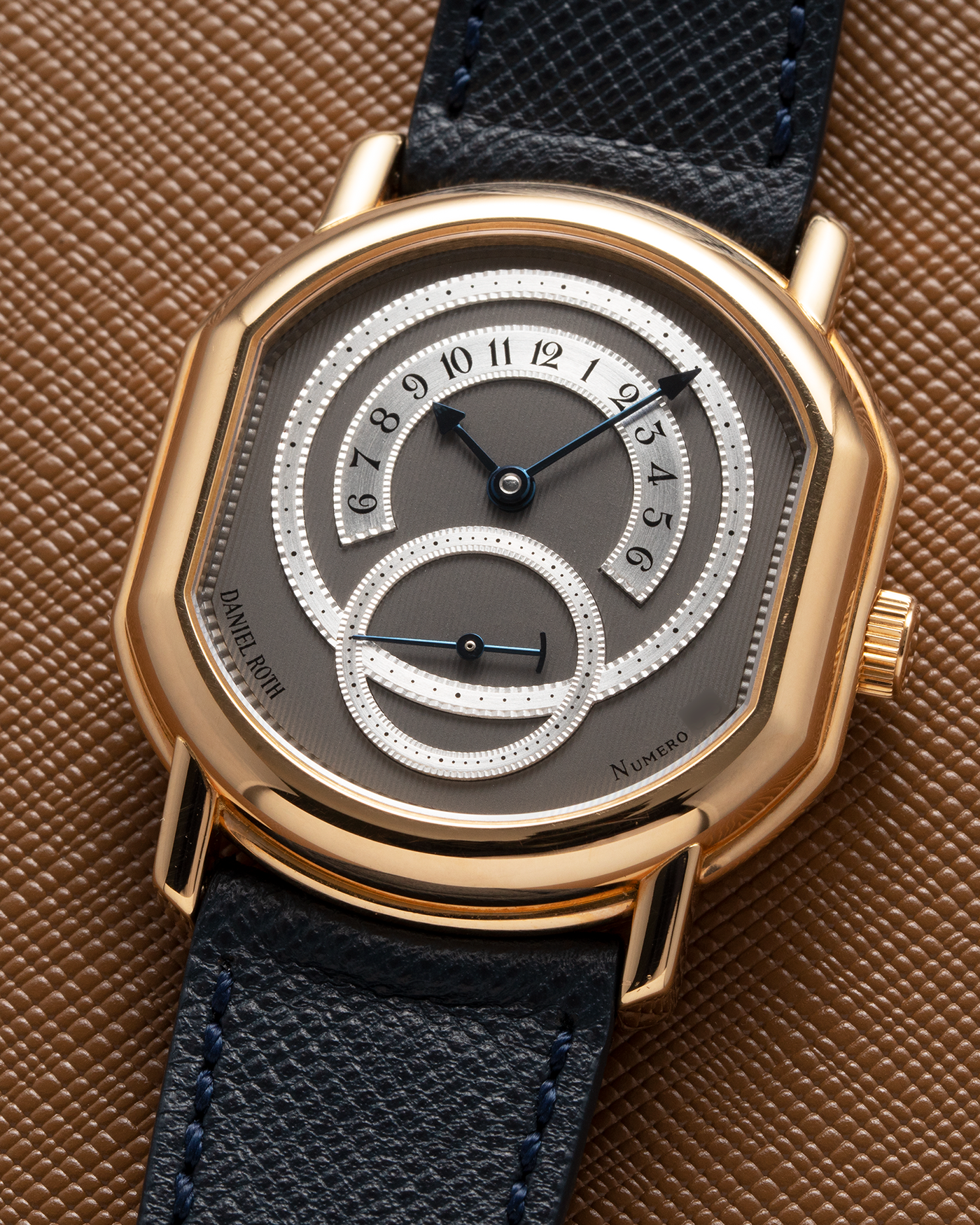 Brand: Daniel Roth Year: 1990’s Model: C127 Material: 18k Yellow Gold Movement: Lemania 27LN with Retrograde Function Case Diameter: 35mm X 38mm Strap: Molequin Navy Blue Textured Calf Strap and 18k Yellow Gold Daniel Roth Tang Buckle