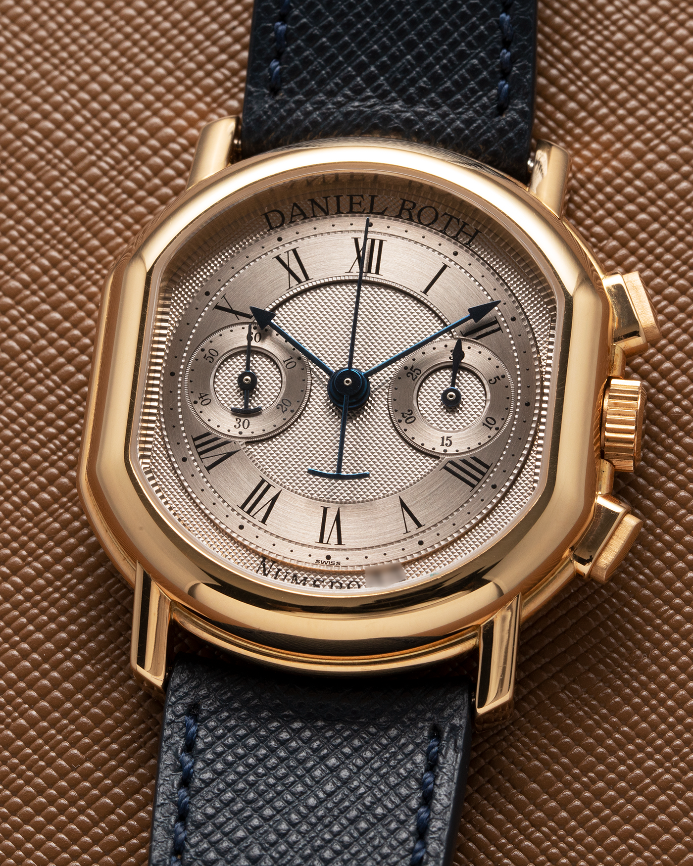 Brand: Daniel Roth Year: 1990’s Model: C147 Material: 18k Yellow Gold Movement: Lemania 2320 Case Diameter: 35mm X 38mm Strap: Molequin Navy Blue Textured Calf Strap and 18k Yellow Gold Daniel Roth Tang Buckle