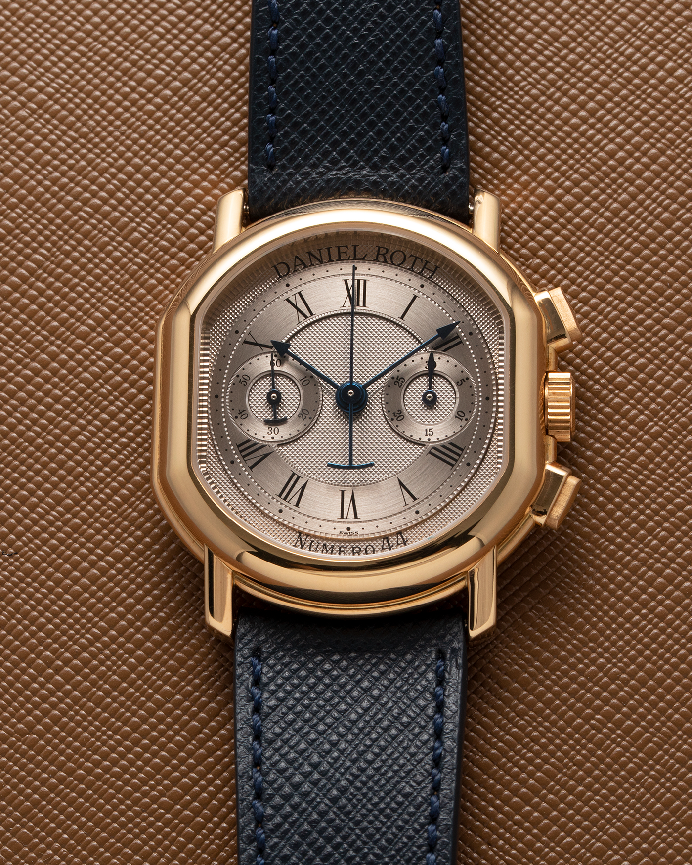 Brand: Daniel Roth Year: 1990’s Model: C147 Material: 18k Yellow Gold Movement: Lemania 2320 Case Diameter: 35mm X 38mm Strap: Molequin Navy Blue Textured Calf Strap and 18k Yellow Gold Daniel Roth Tang Buckle