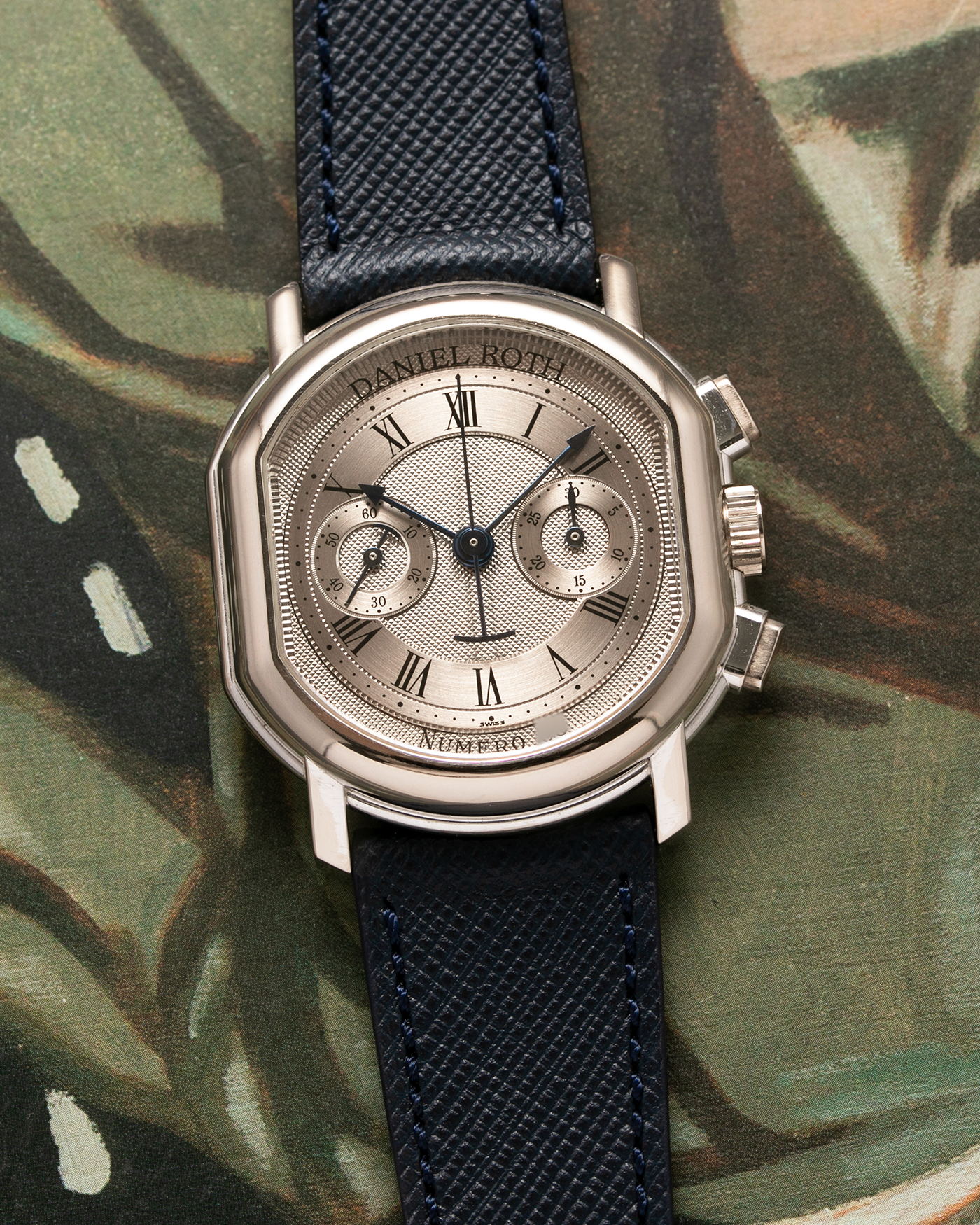 Brand: Daniel Roth Year: 1990’s Model: 2147 Material: 18k White Gold Movement: Lemania 2320 Case Diameter: 35mm X 38mm Strap: Molequin Navy Blue Textured Calf Strap and 18k White Gold Daniel Roth Tang Buckle