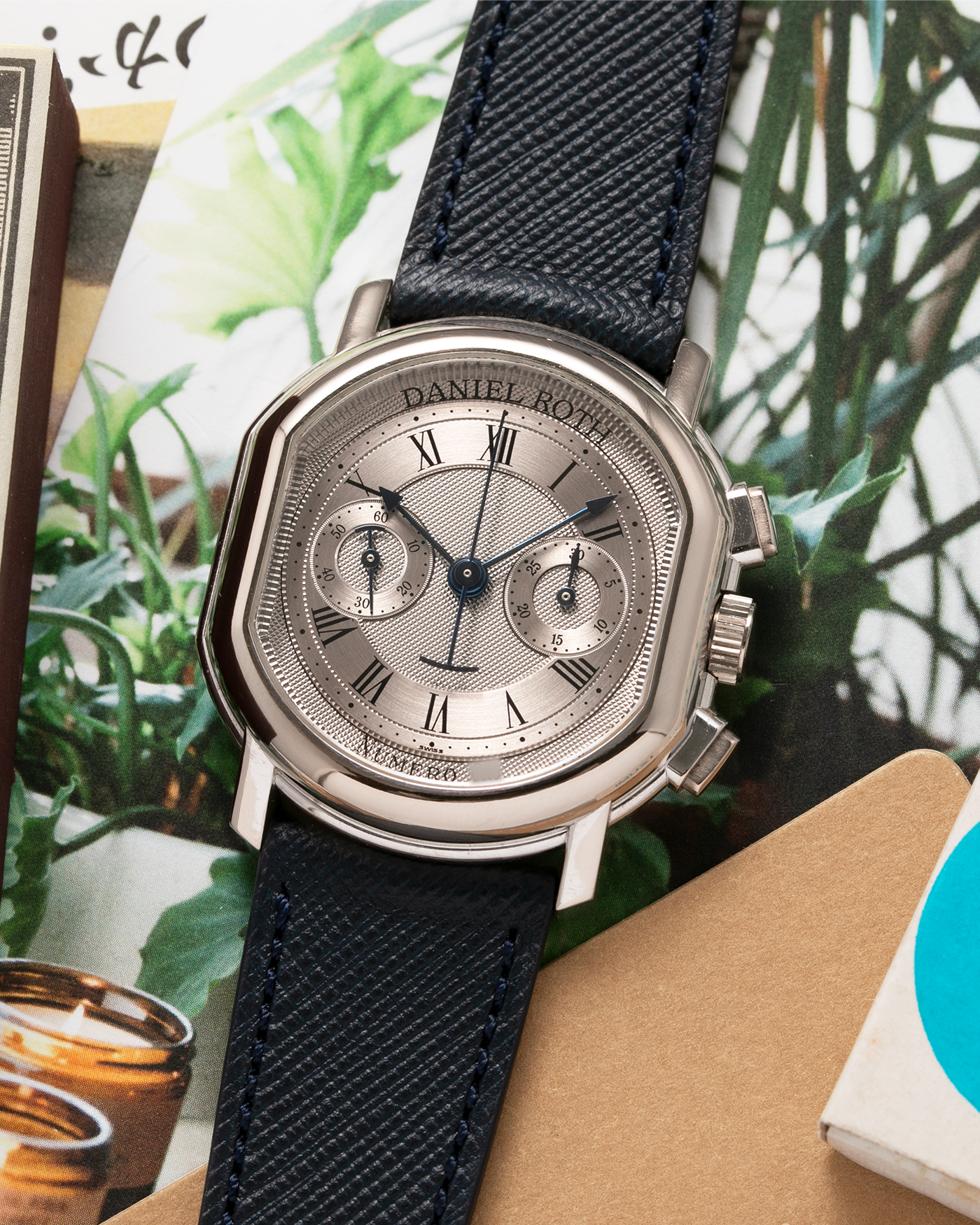 Brand: Daniel Roth Year: 1990’s Model: 2147 Material: 18k White Gold Movement: Lemania 2320 Case Diameter: 35mm X 38mm Strap: Molequin Navy Blue Textured Calf Strap and 18k White Gold Daniel Roth Tang Buckle