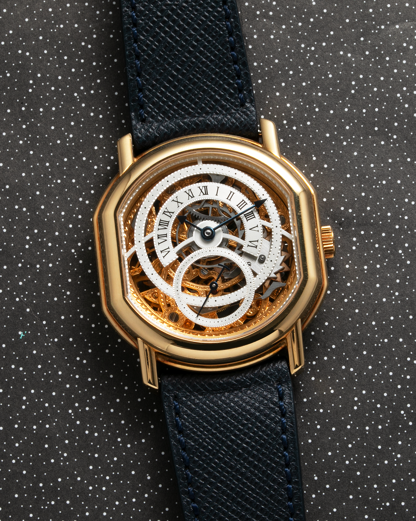 Brand: Daniel Roth Year: 1990’s Model: 2127 Skeleton Material: 18k Yellow Gold Movement: Lemania 27LN with Retrograde Function Case Diameter: 35mm X 38mm Strap: Molequin Navy Blue Textured Calf Strap and 18k Yellow Gold Daniel Roth Tang Buckle