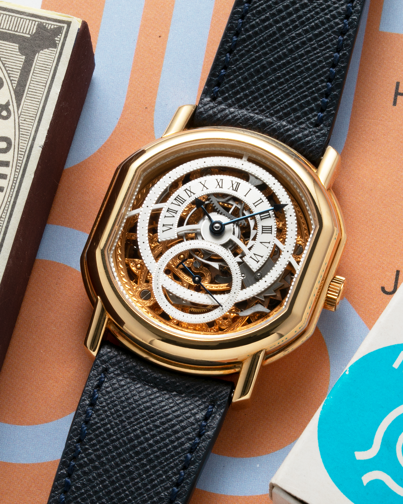 Brand: Daniel Roth Year: 1990’s Model: 2127 Skeleton Material: 18k Yellow Gold Movement: Lemania 27LN with Retrograde Function Case Diameter: 35mm X 38mm Strap: Molequin Navy Blue Textured Calf Strap and 18k Yellow Gold Daniel Roth Tang Buckle
